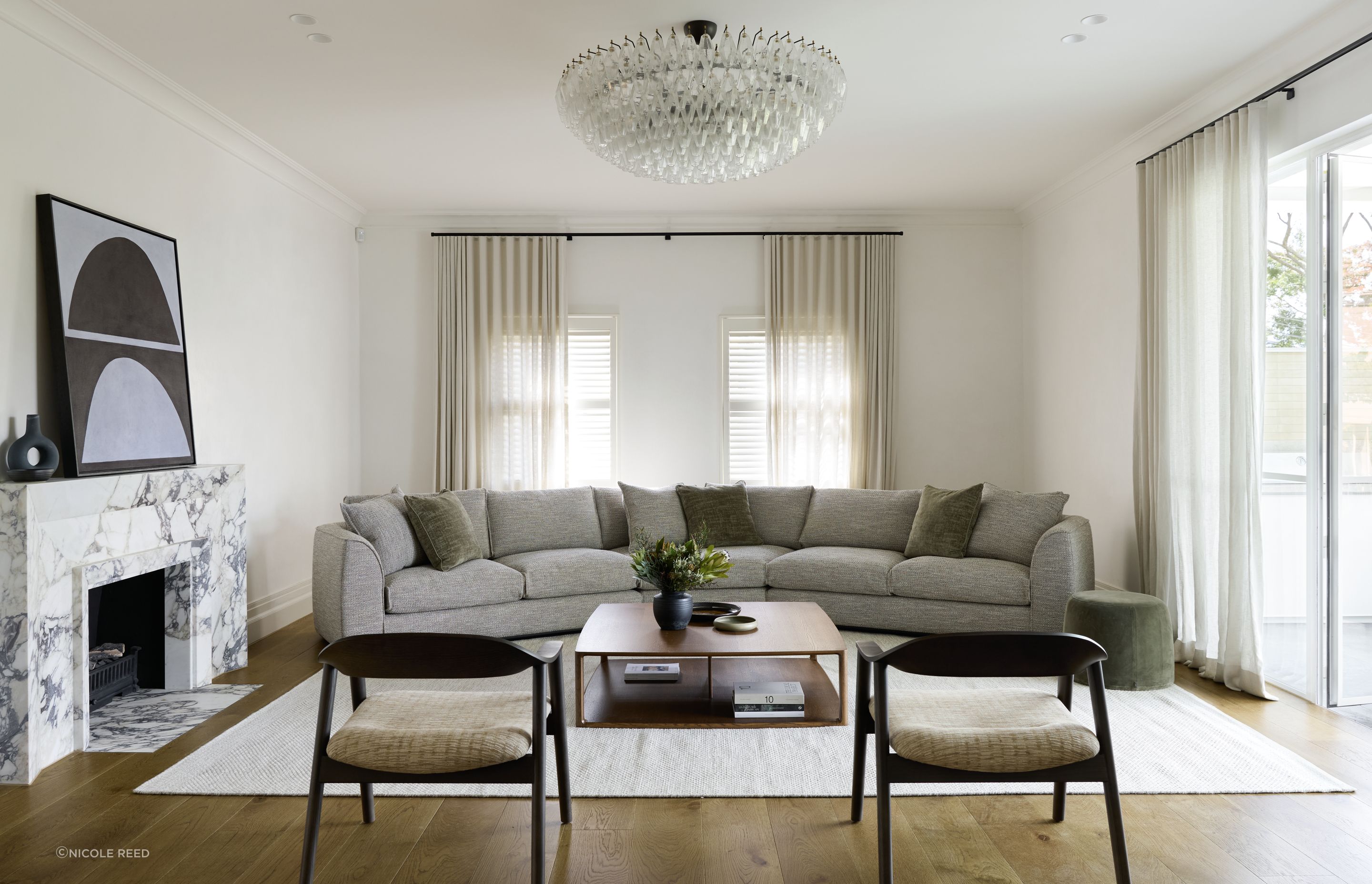 The Erskine sofa featuring a 30 Degrees Module, a fresh addition to the existing Erskine modular sofa. Placed at the centre of the sofa layout, this new module forms an impressive, curved sofa, perfect for larger spaces. This sofa is complemented by the new Karm Lounge Chairs, also presented in the smoked oak stain.