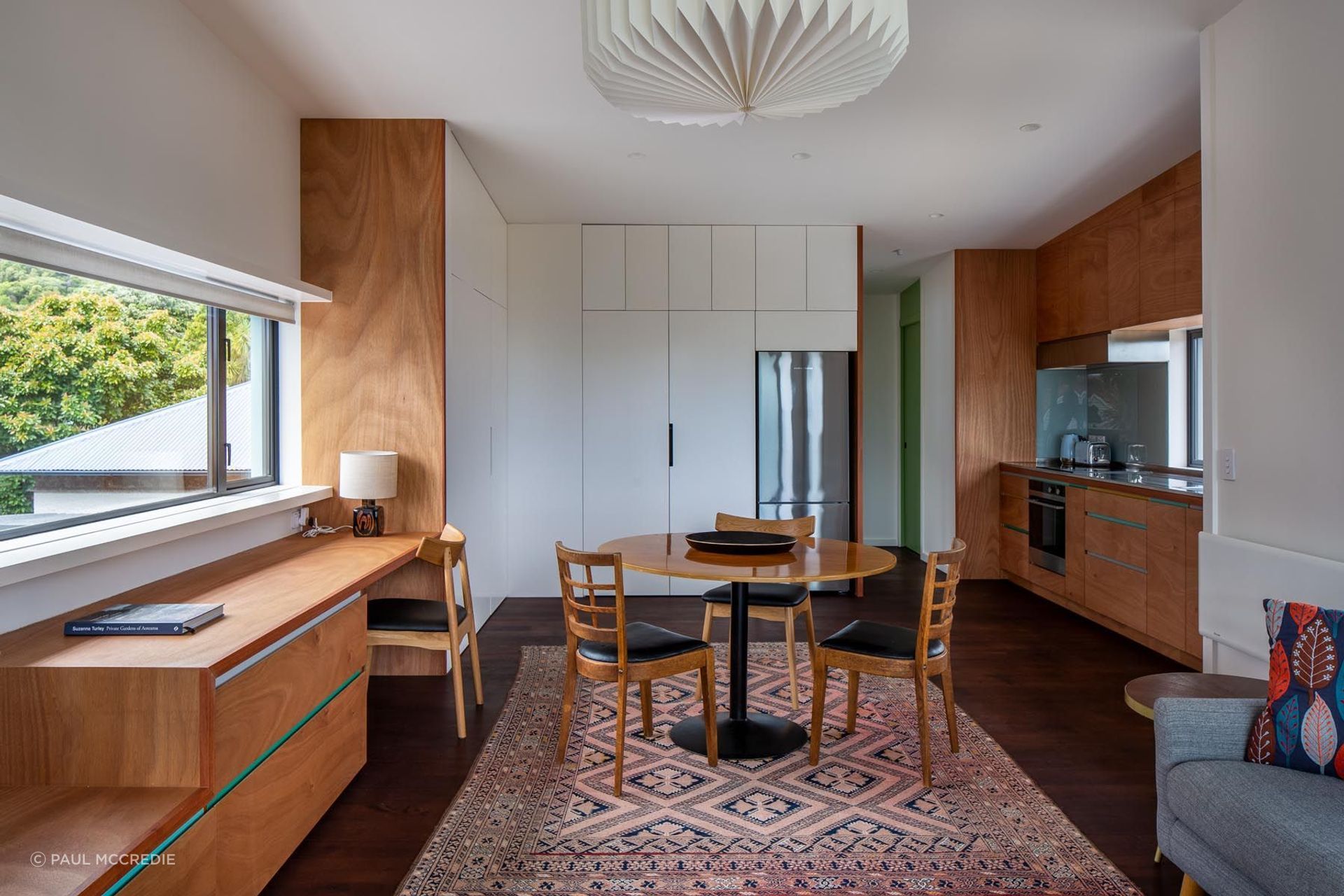 The upstairs one-bedroom apartment shares its design style with the main house. There are glimpses of sea view from the kitchen sink.