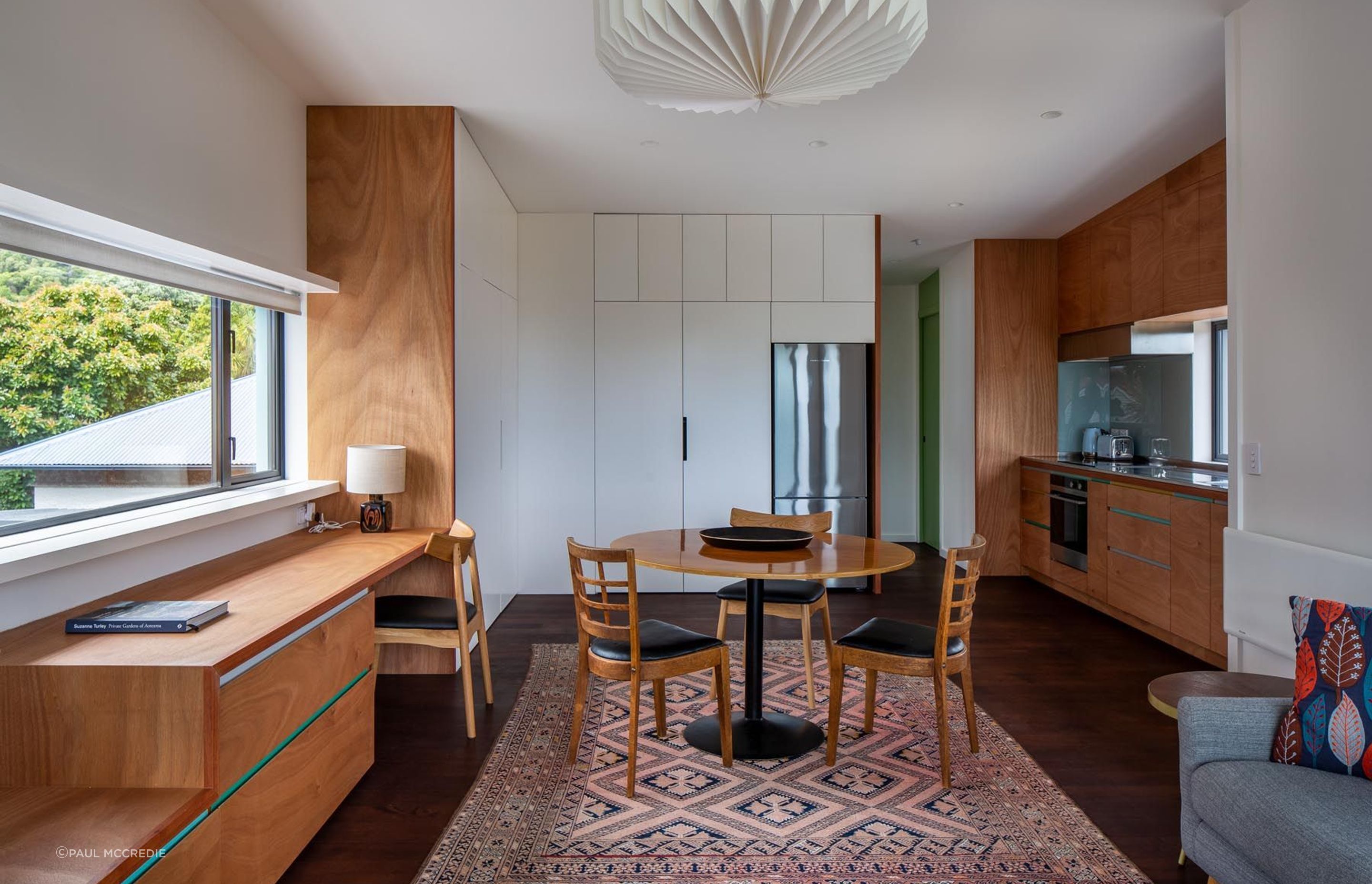 The upstairs one-bedroom apartment shares its design style with the main house. There are glimpses of sea view from the kitchen sink.