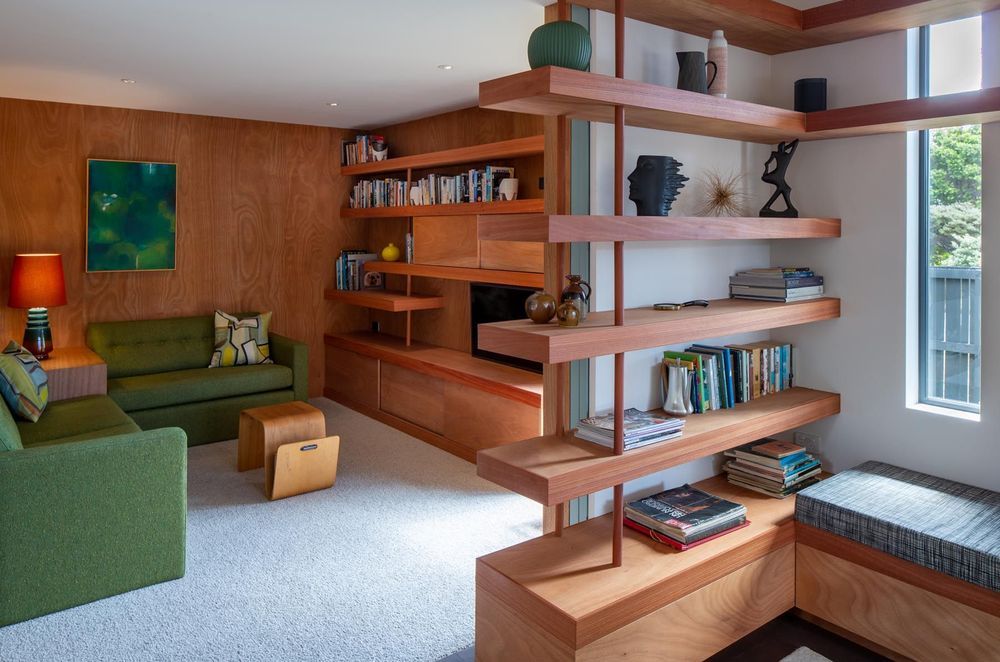 The blue doors slide away to open the den to the lounge. “That flexible room was quite important, a room that they could close down to watch TV or be part of the living main living space.” The house also has a study/workroom.