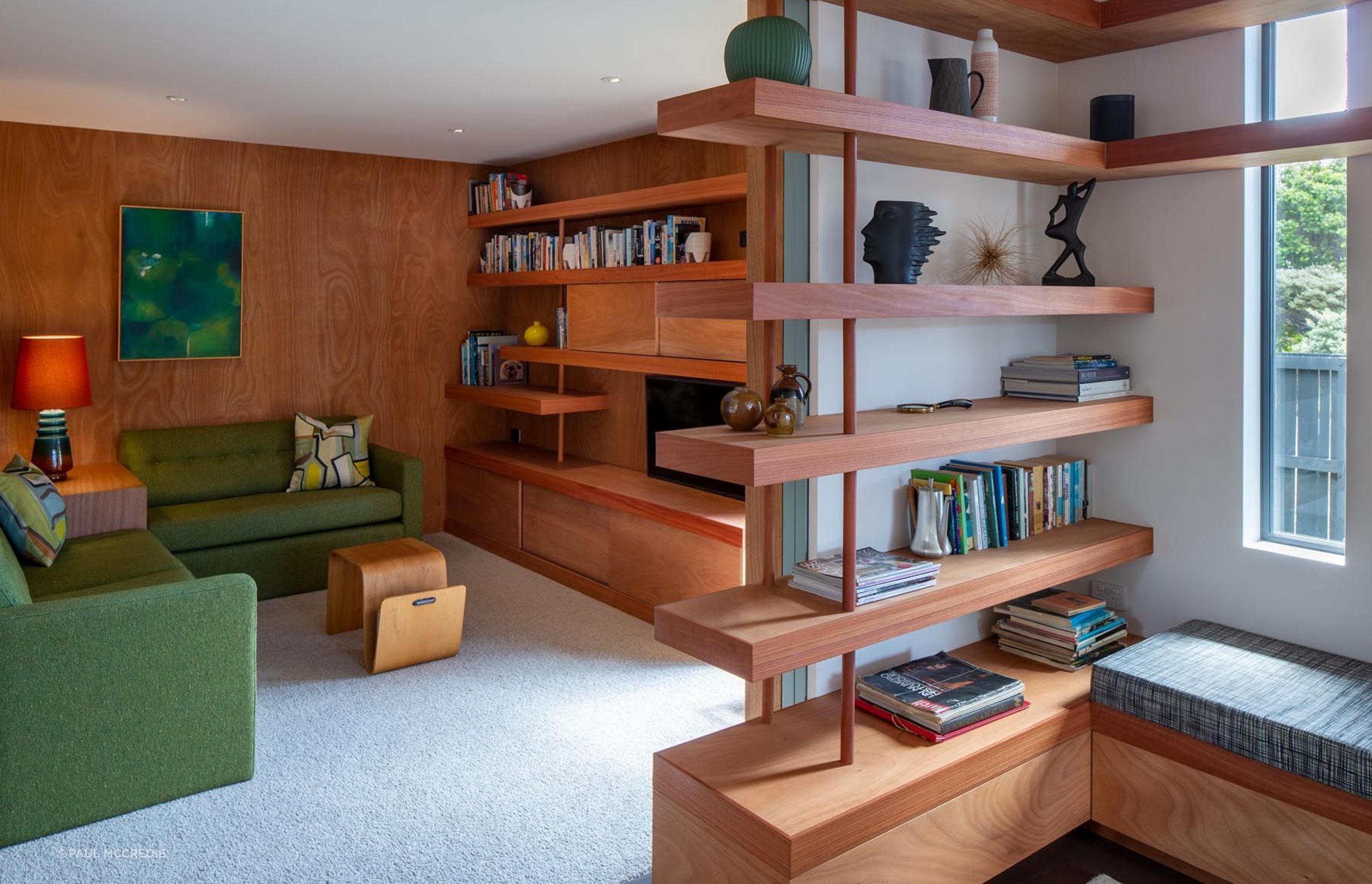 The blue doors slide away to open the den to the lounge. “That flexible room was quite important, a room that they could close down to watch TV or be part of the living main living space.” The house also has a study/workroom.