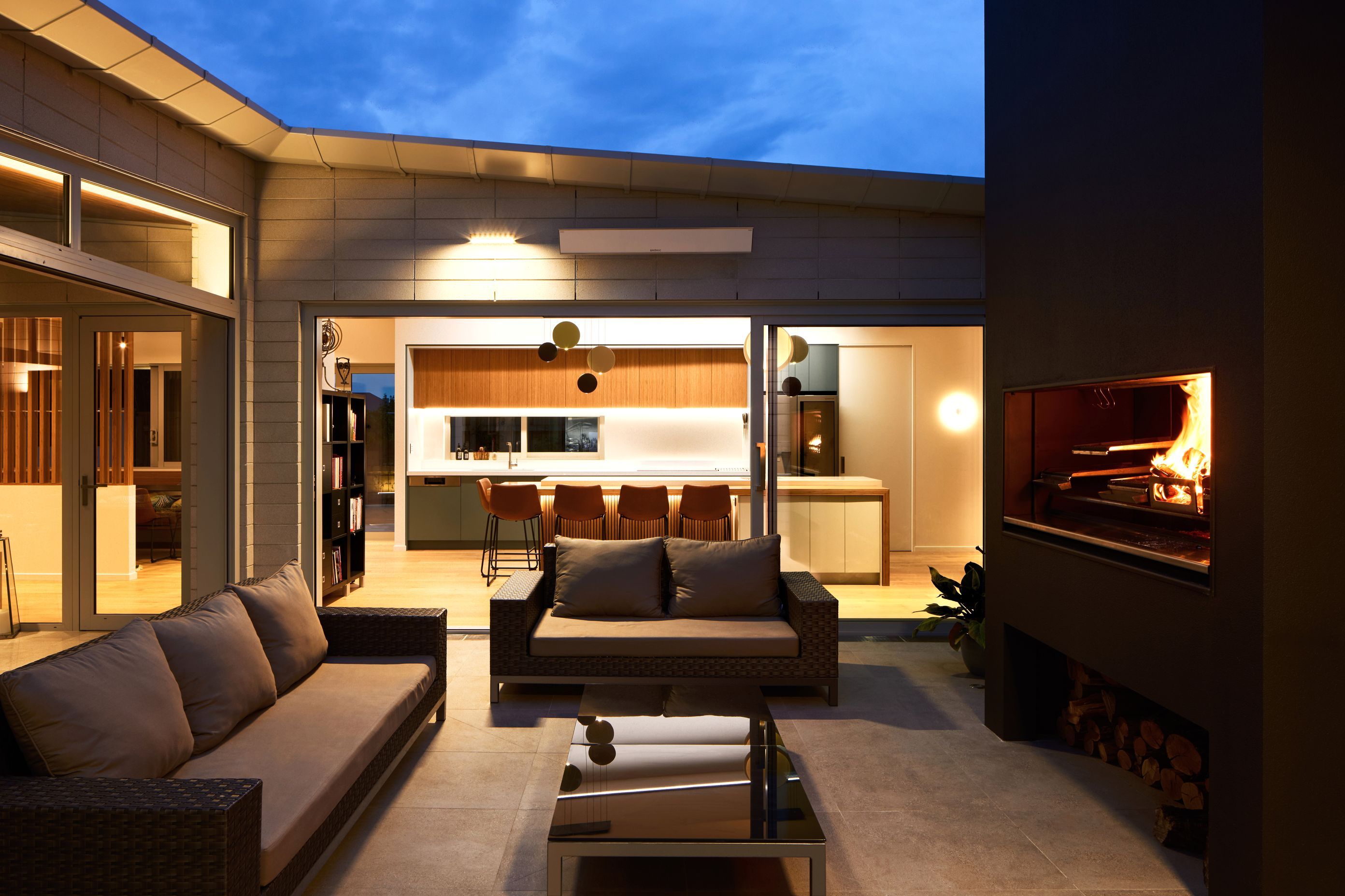 The courtyard is built around an outdoor kitchen, the Escea EK1550. “As a big entertainer and hailing from Spain, the homeowner cooks a lot of paella and asado-style meats.”