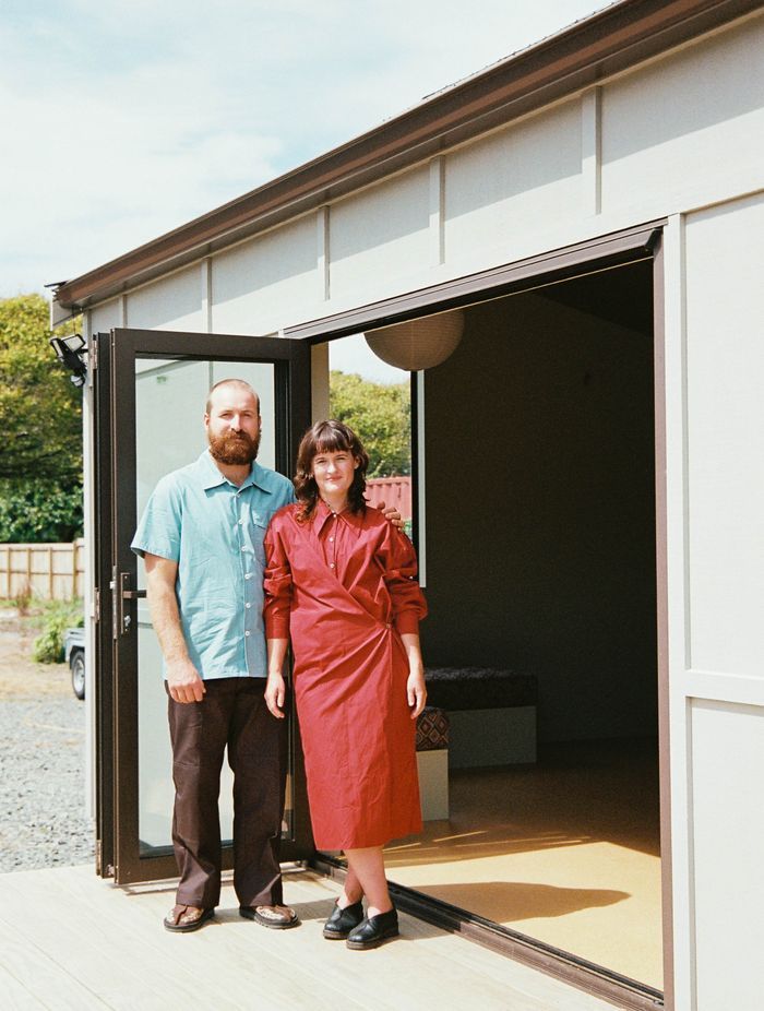 Starr (left) and Scapens (right) stand at the entrance to a completed Homewerk cabin.