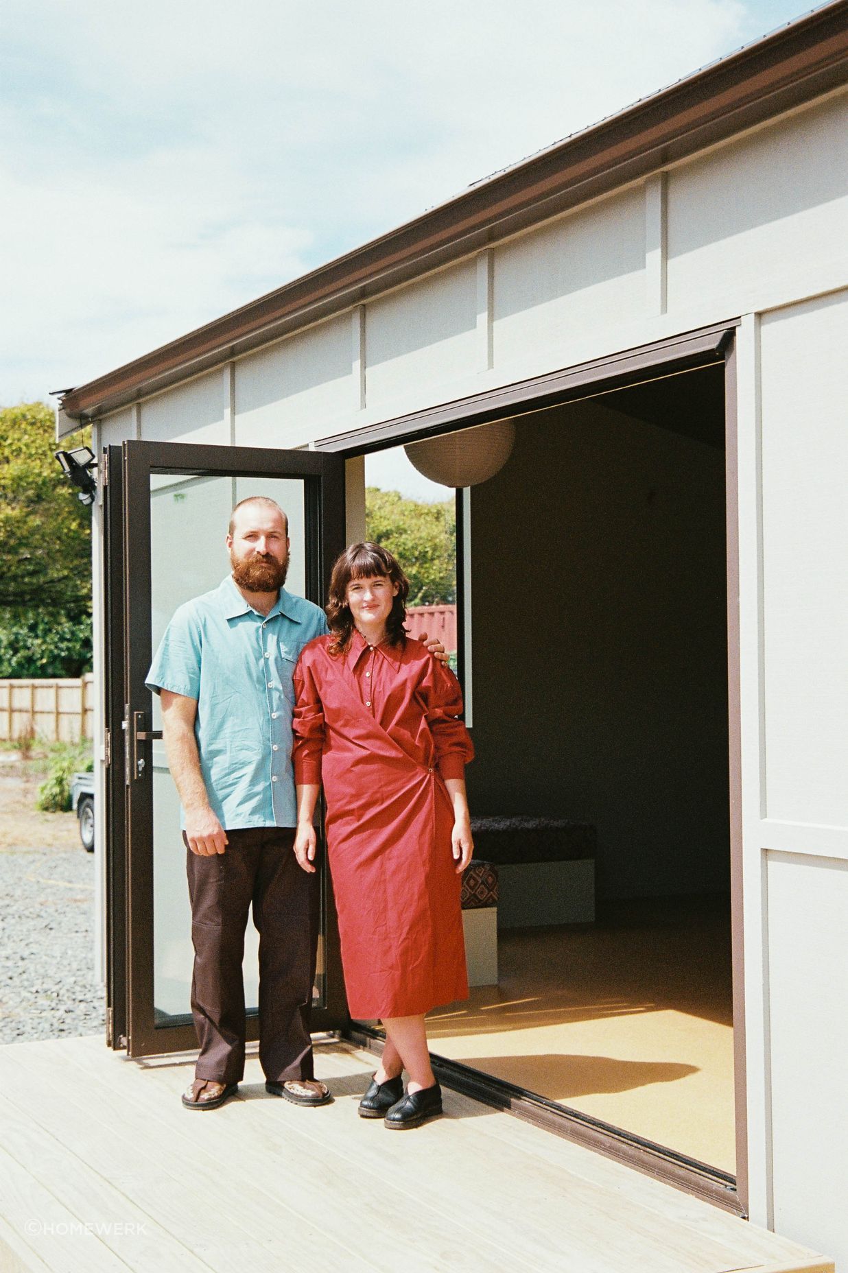 Starr (left) and Scapens (right) stand at the entrance to a completed Homewerk cabin.