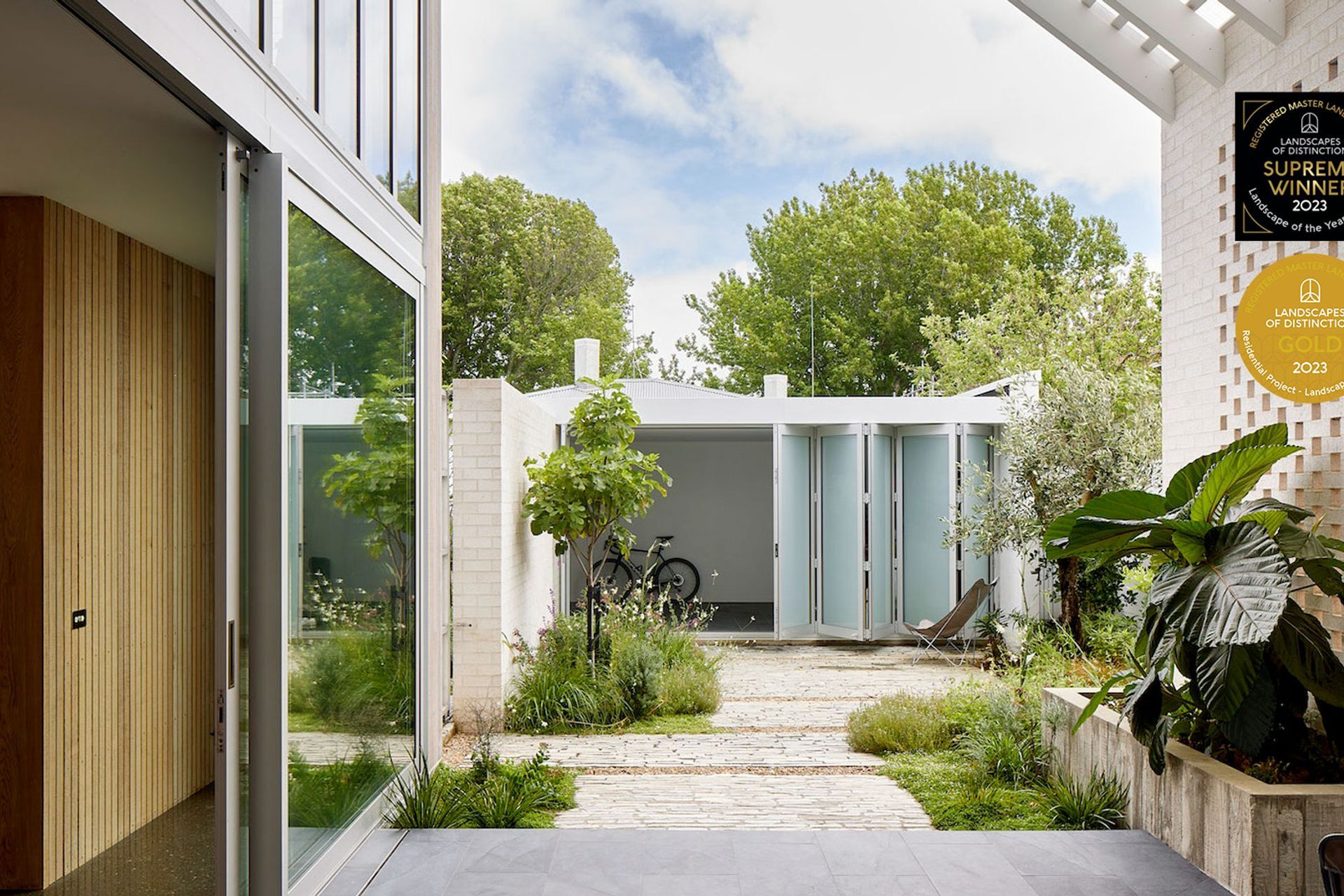 Small urban courtyard planted with a combination of flowering perennials and Mediterranean shrubs. Designer: Andy Hamilton.