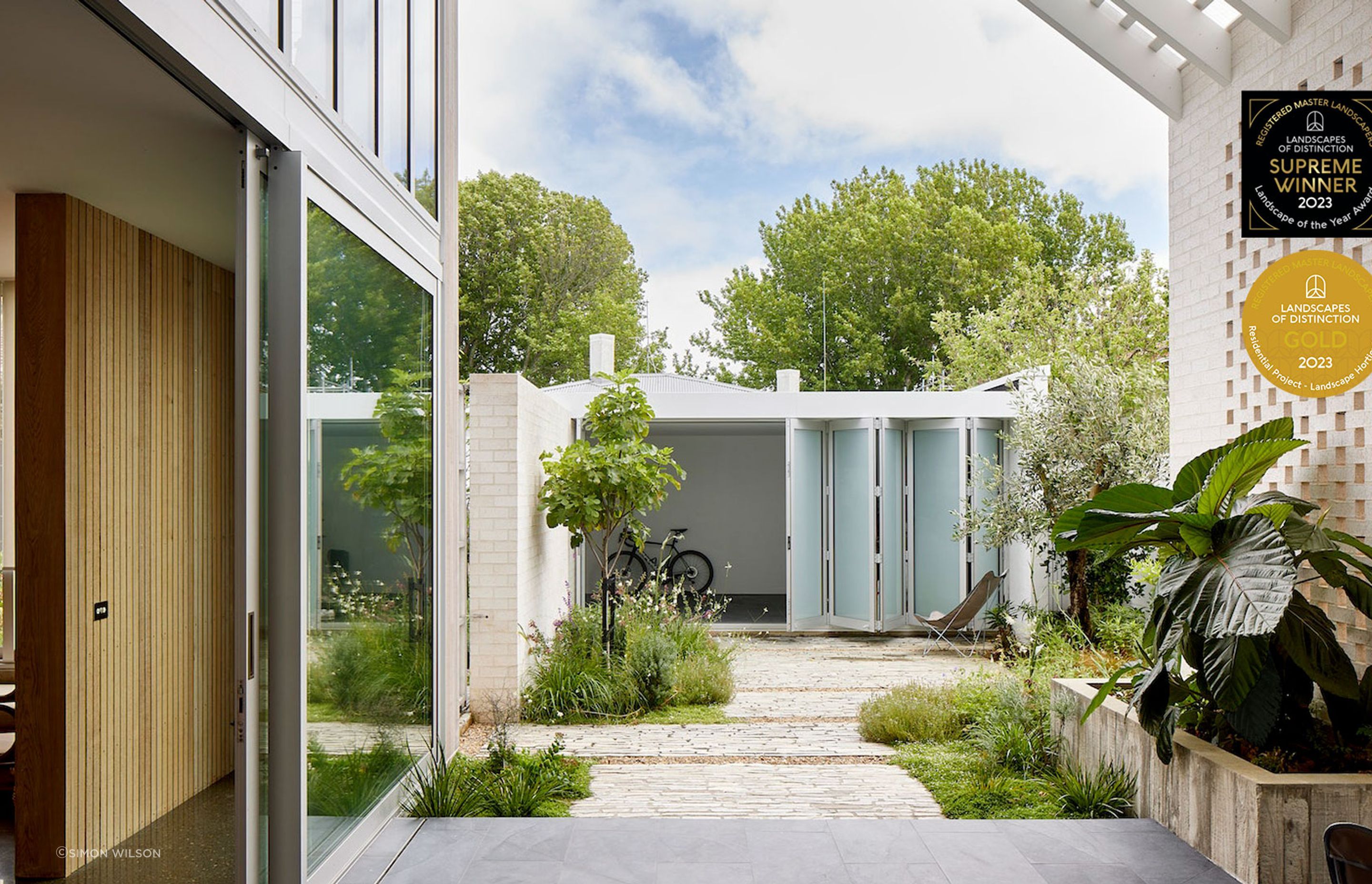 Small urban courtyard planted with a combination of flowering perennials and Mediterranean shrubs. Designer: Andy Hamilton.