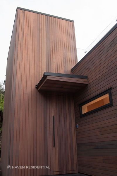 The cedar cladding blends in with the rich browns and greens of the surrounding bush, complementing the land rather than distracting from it.