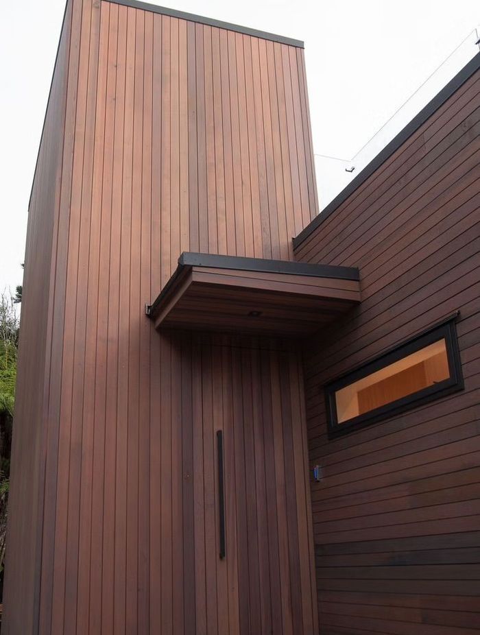 The cedar cladding blends in with the rich browns and greens of the surrounding bush, complementing the land rather than distracting from it.