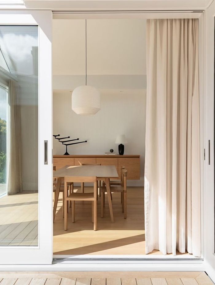 The soft palette of timber and white creates a gentle, relaxing atmosphere.