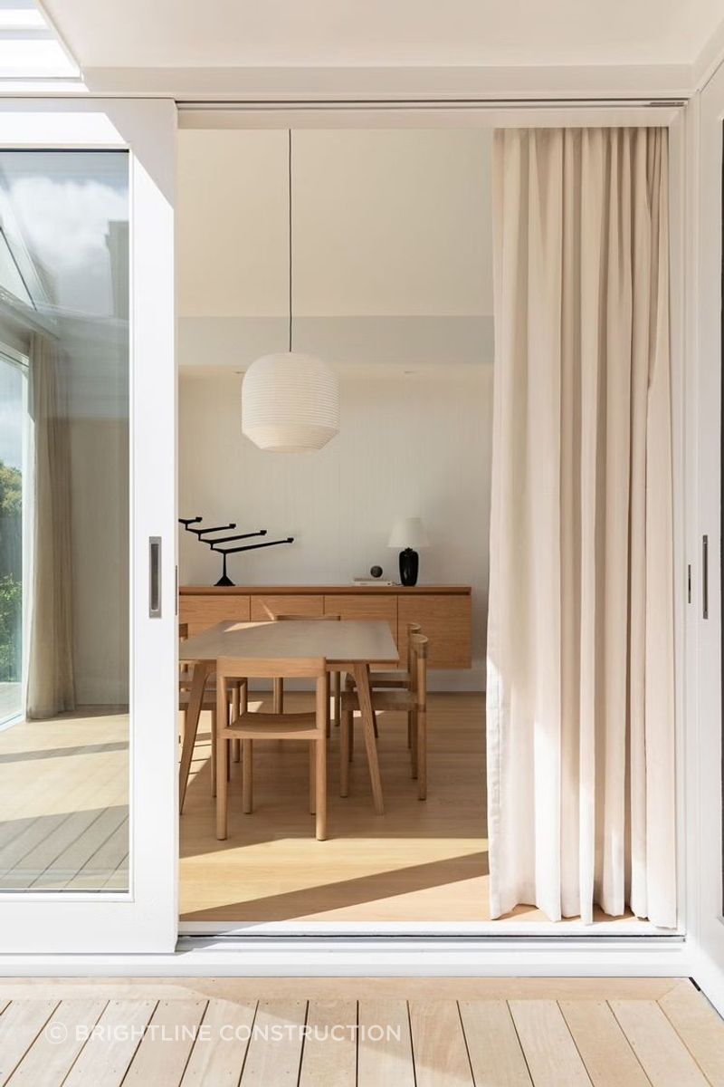 The soft palette of timber and white creates a gentle, relaxing atmosphere.