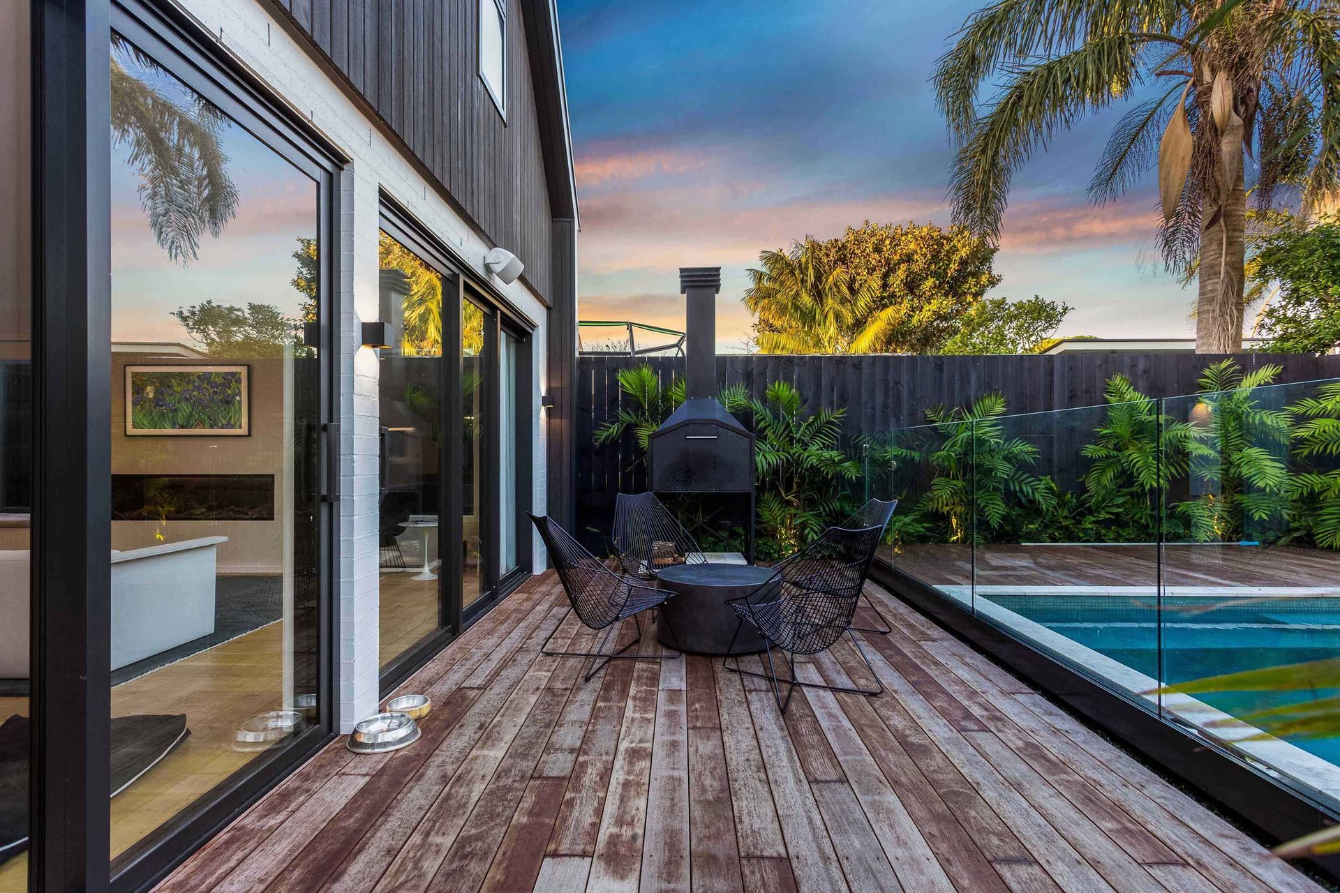An outdoor living space is tucked neatly between the living space and pool, and allows seamless flow from indoors to outdoors.