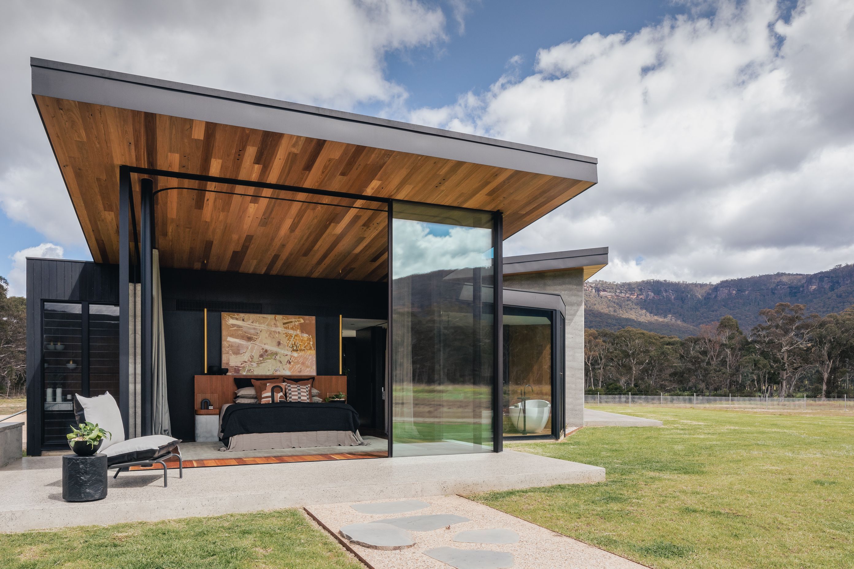 The master suite blends seamlessly into the outdoor environment.