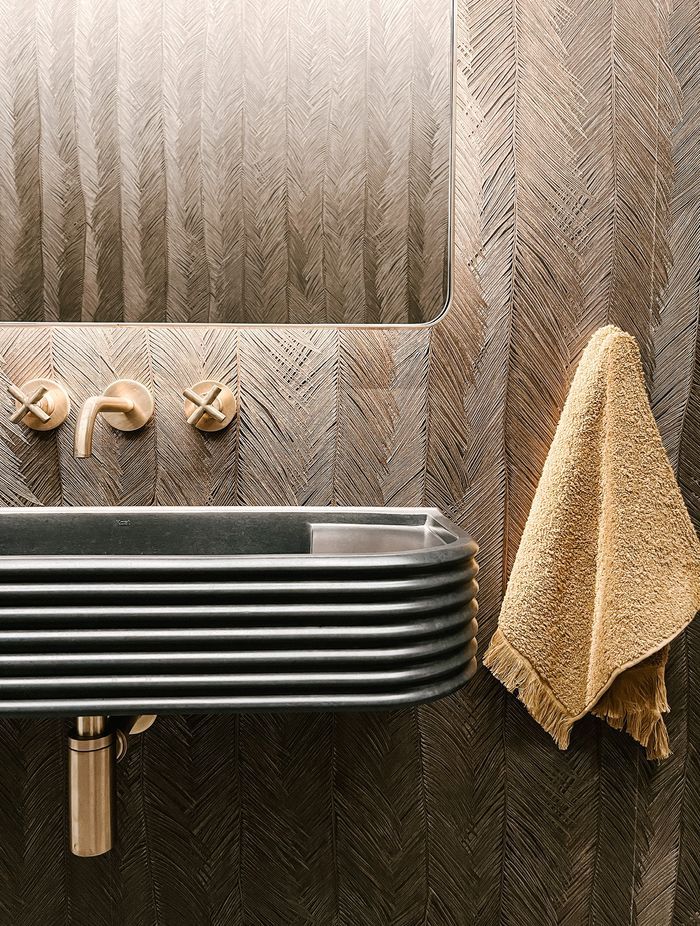 The wall-mounted Chap tapware in brushed brass is from Plumbline. “I love the dark colour with the brass.”
