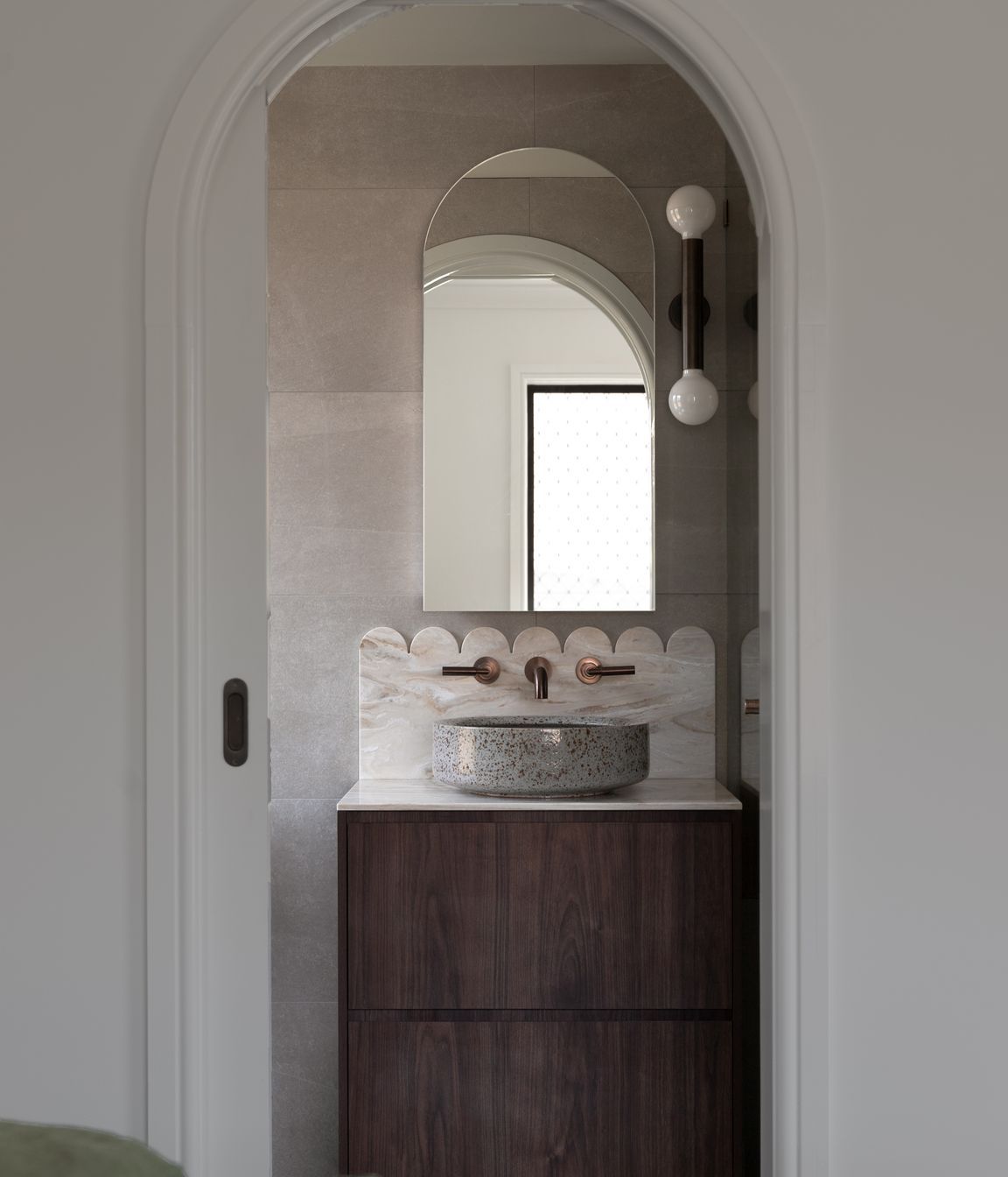 The ensuite features a scallop Corian detail, cut by the team at Best Kitchens.