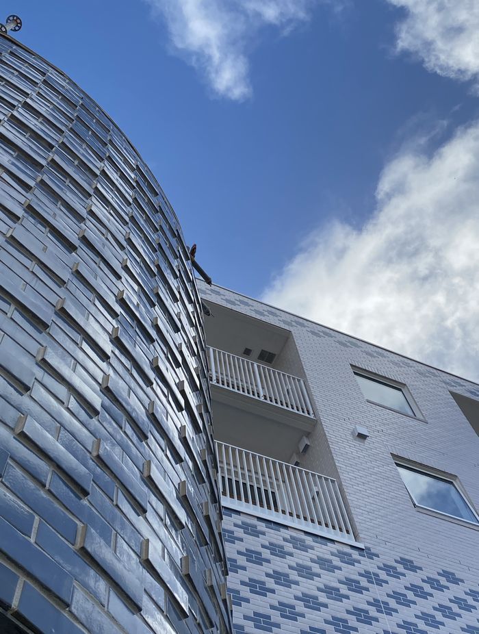 Work in progress photos show the playful expression of pattern and colour through the brick façade.
