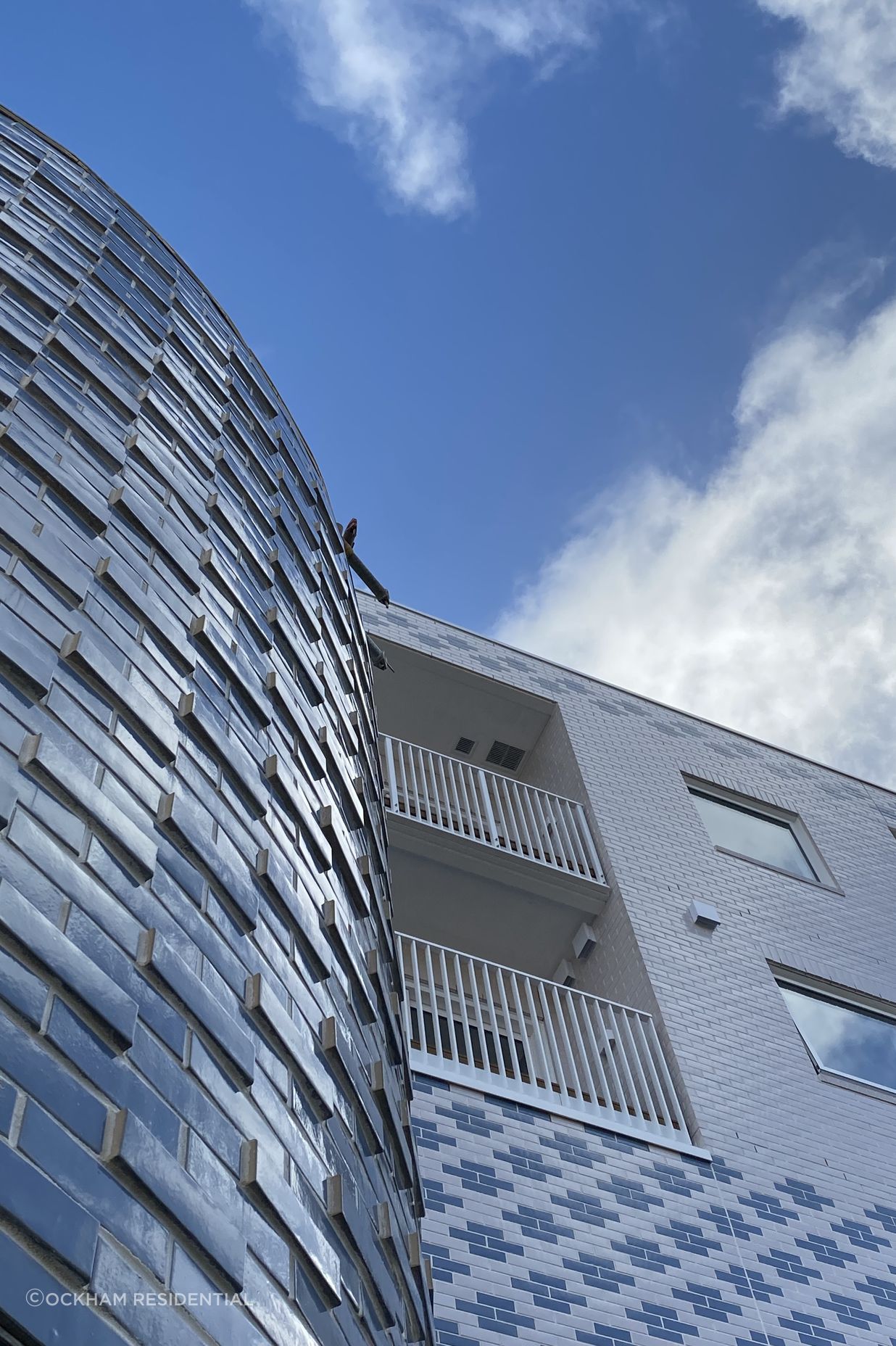 Work in progress photos show the playful expression of pattern and colour through the brick façade.