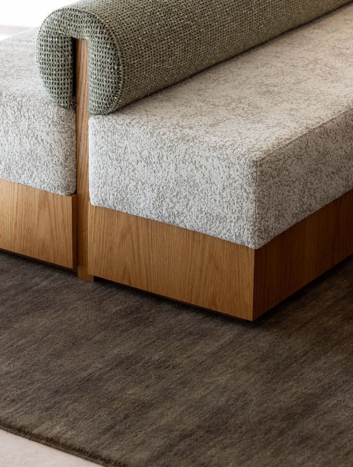 The custom ottoman was made by Evolution Construction & Interiors.