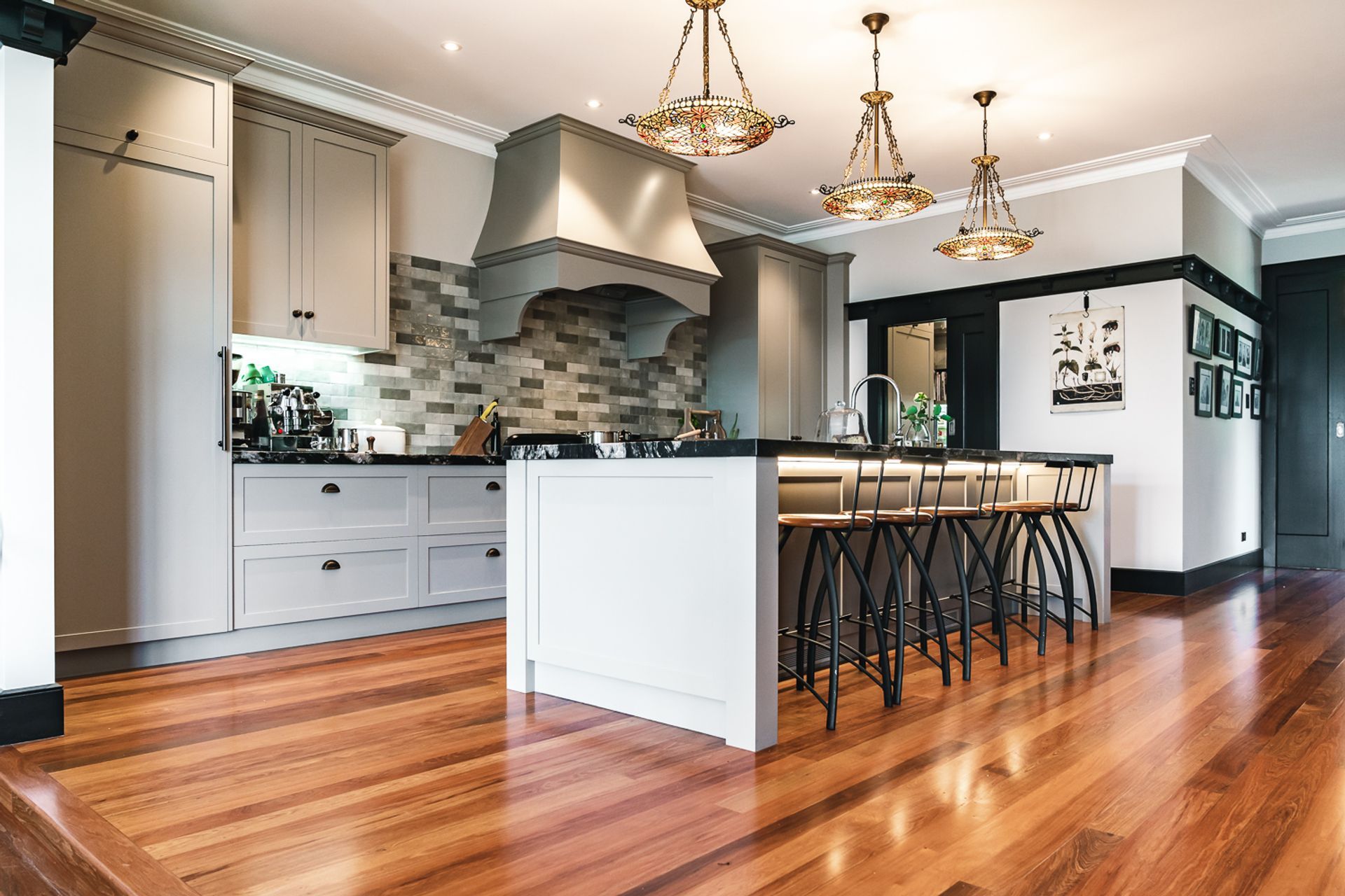 The kitchen features leathered granite benchtops from Stone Warehouse, with shaker style cabinets crafted by Neil Taylor Cabinetmaker & Design.