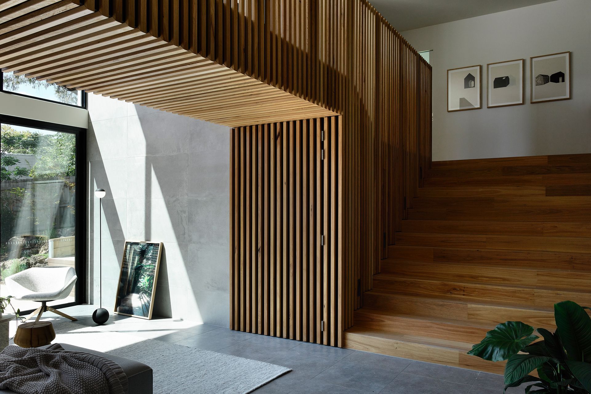 Timber graces the staircase and bridge that connects the upstairs areas.