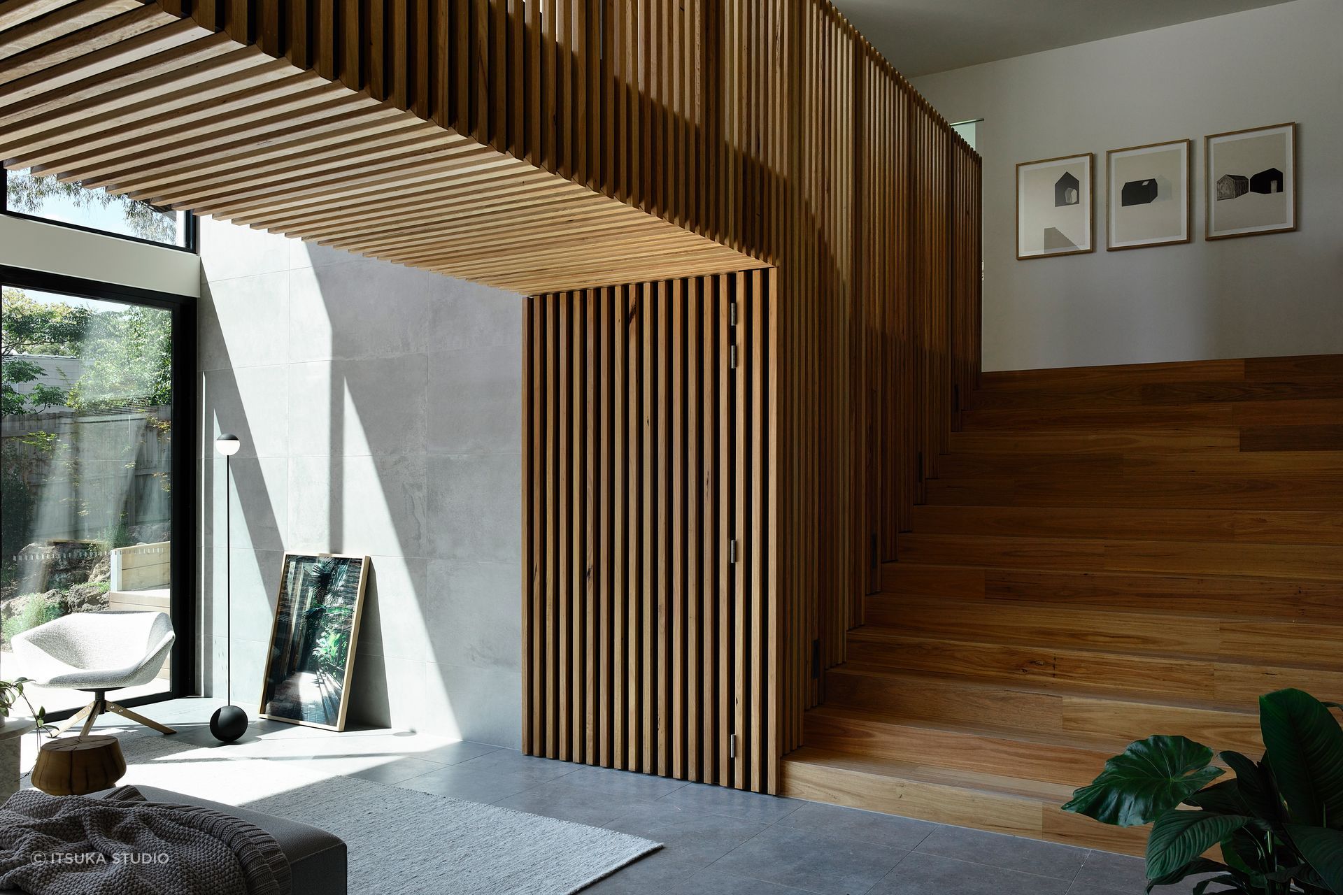 Timber graces the staircase and bridge that connects the upstairs areas.