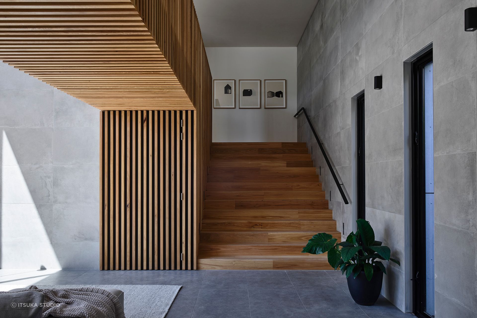 A neutral palette has been used for the home's interior. The wide timber staircase leads to the client's study nook.