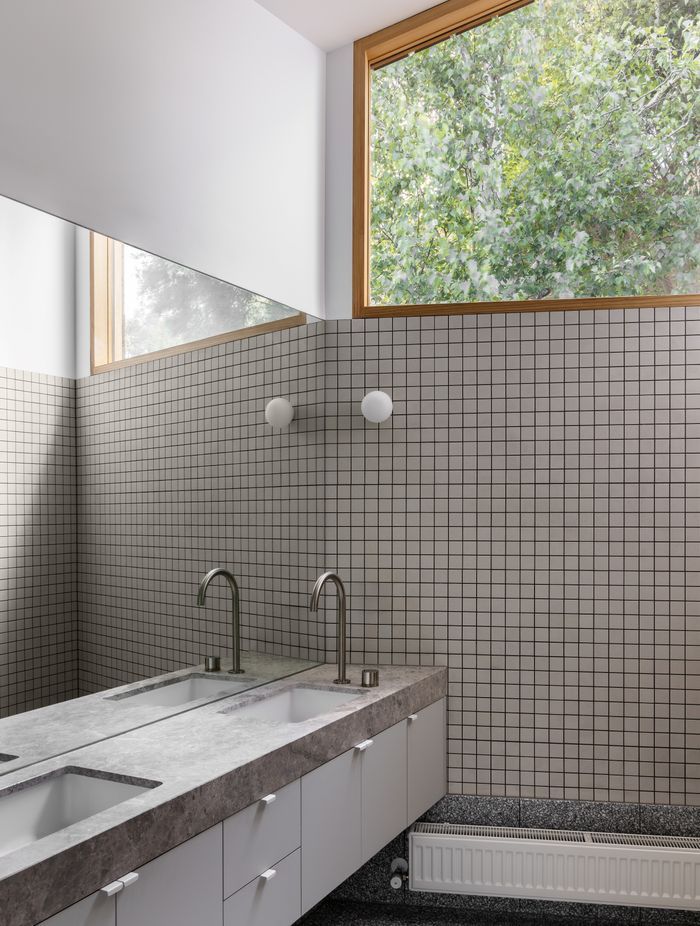 High windows provide privacy while welcoming light and views into the ensuite.