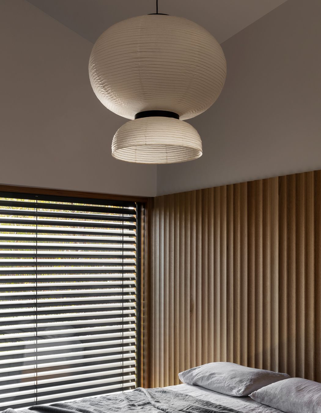The wood paneling doubles as a bedhead in the main bedroom.