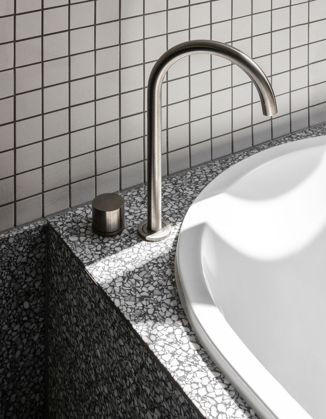 Minimalist hardware allows the tiling and stoneware to shine.