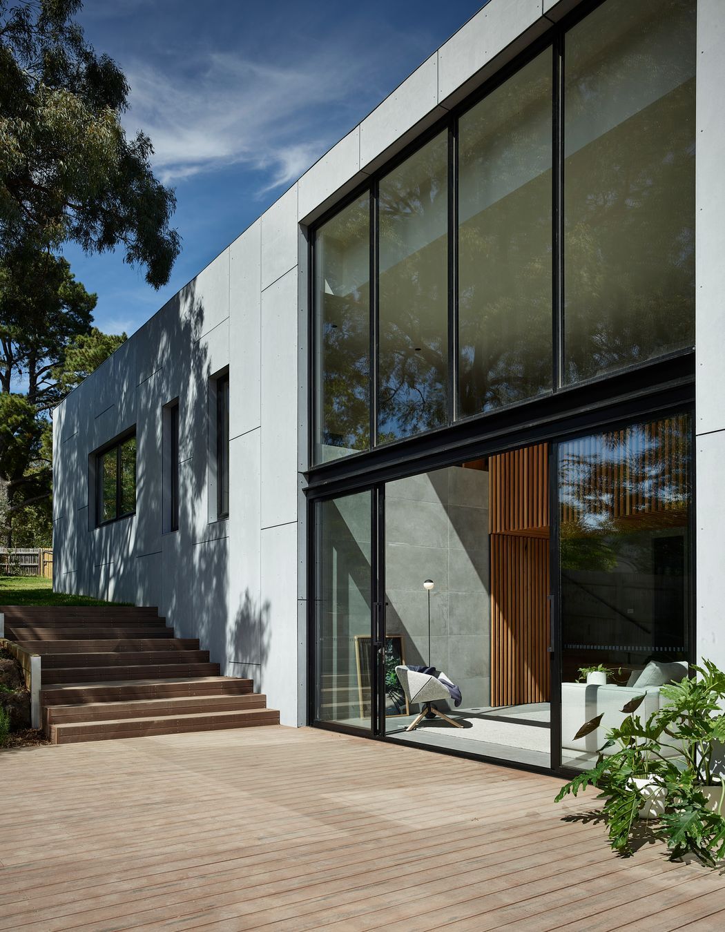 Floor-to-ceiling glazing connects the outside and in, with the deck an extension to the living area.