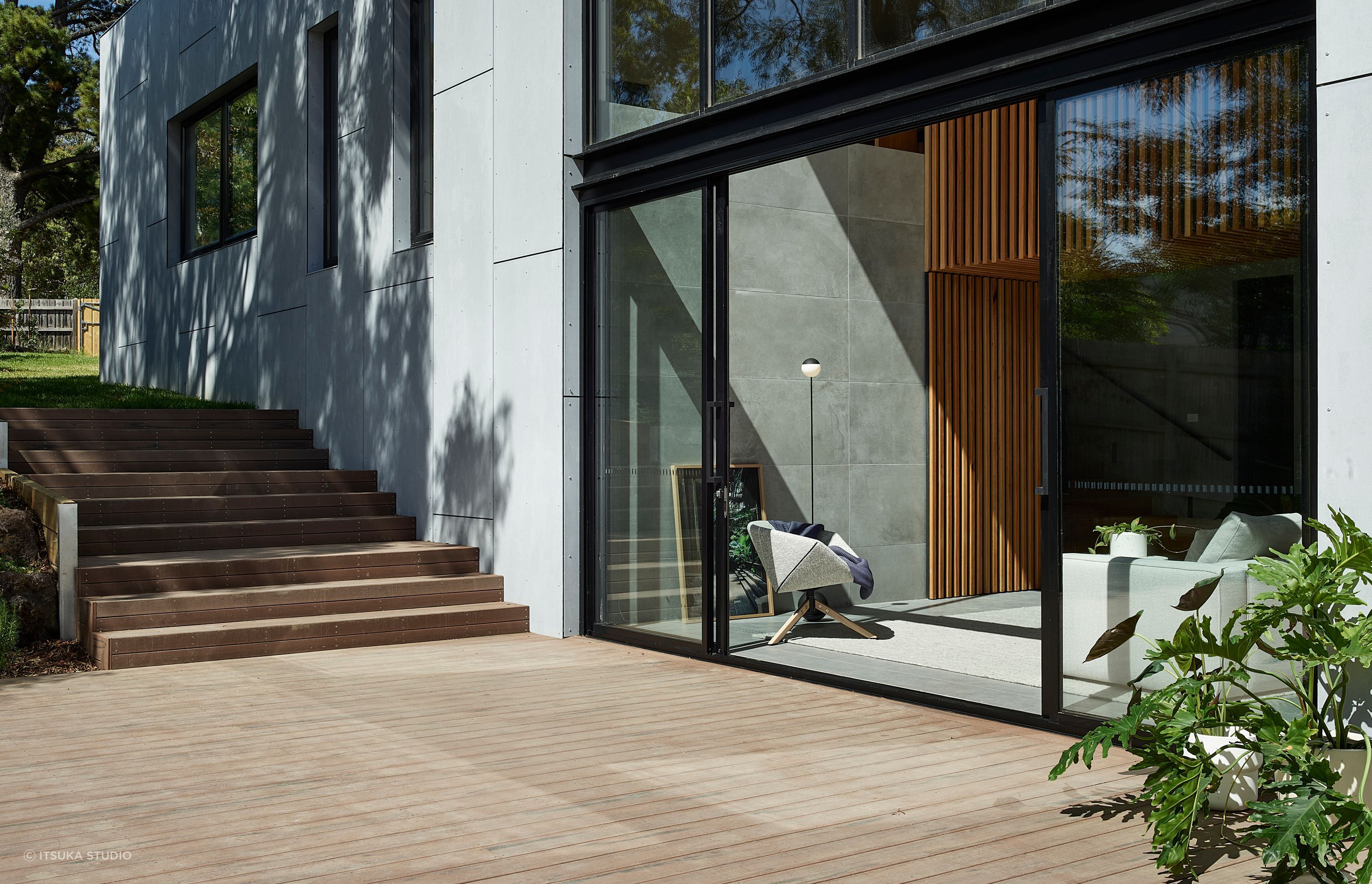 Floor-to-ceiling glazing connects the outside and in, with the deck an extension to the living area.