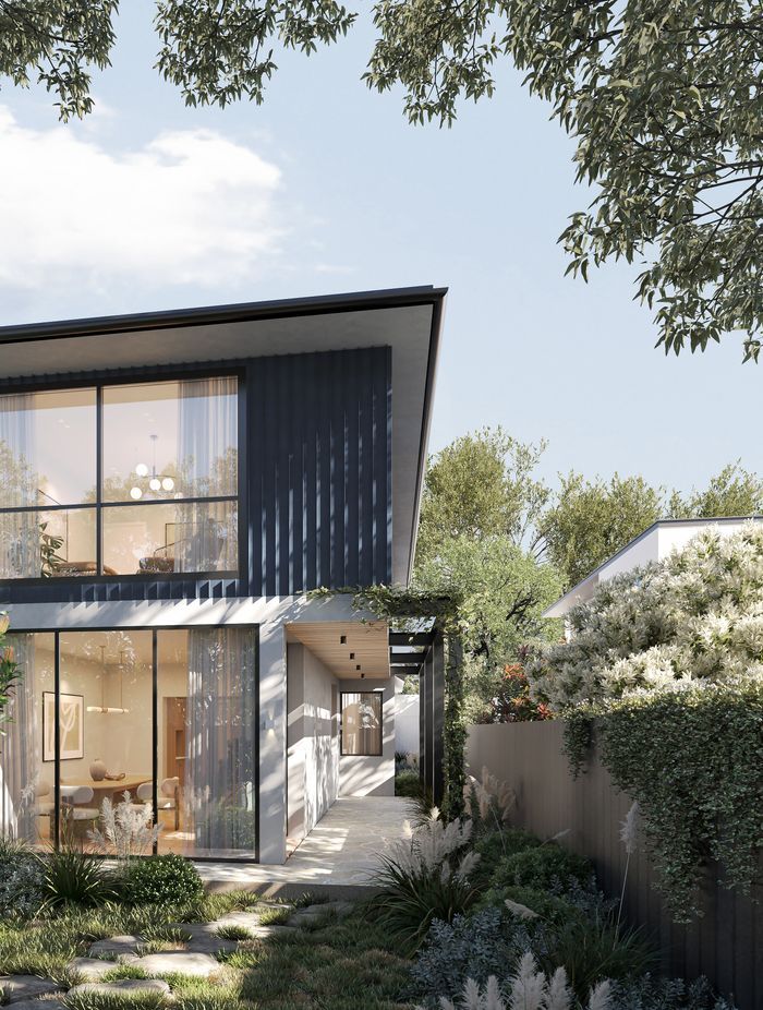 Surrounded by a garden oasis, the home embraces the greenery and natural light through floor-to-ceiling windows in the downstairs living space.