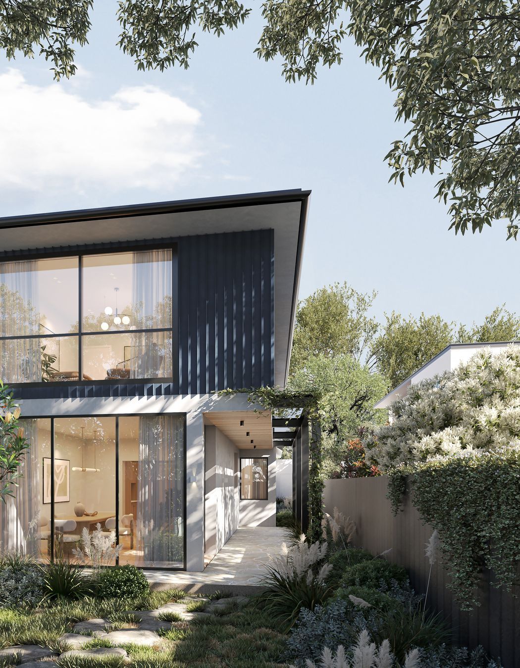 Surrounded by a garden oasis, the home embraces the greenery and natural light through floor-to-ceiling windows in the downstairs living space.