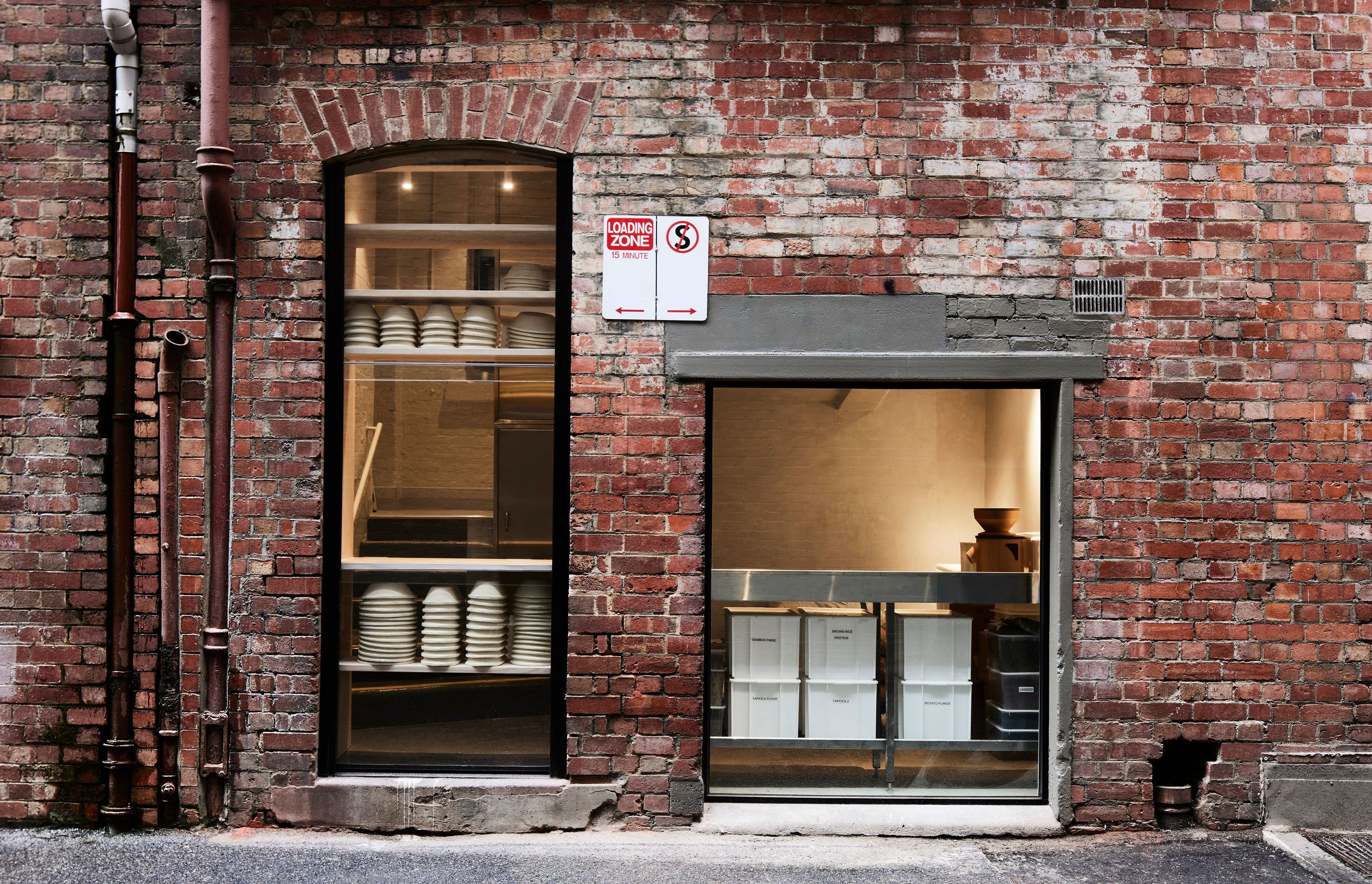 "One of the best design features is the use of the rear of the bakery, which looks into a laneway. Large panels of glass have been added to the heritage facade, showcasing the flour milling and mixing process. This window glows before dawn while Melbourne awakens to the sunrise," shares Felix Goodwin and Elena Nguyen.