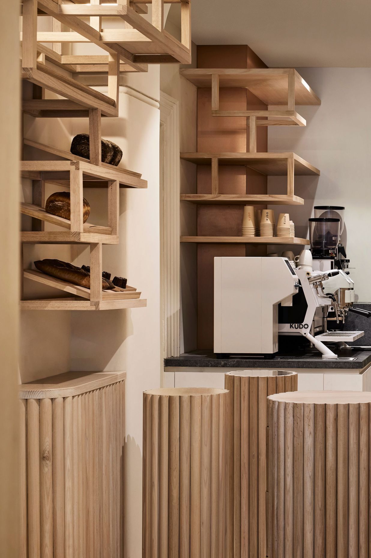 "Canelé-inspired furniture sits on the ground plane, guiding people around the narrow space. The pieces create organic traffic movement, similar to a sculptural garden."
