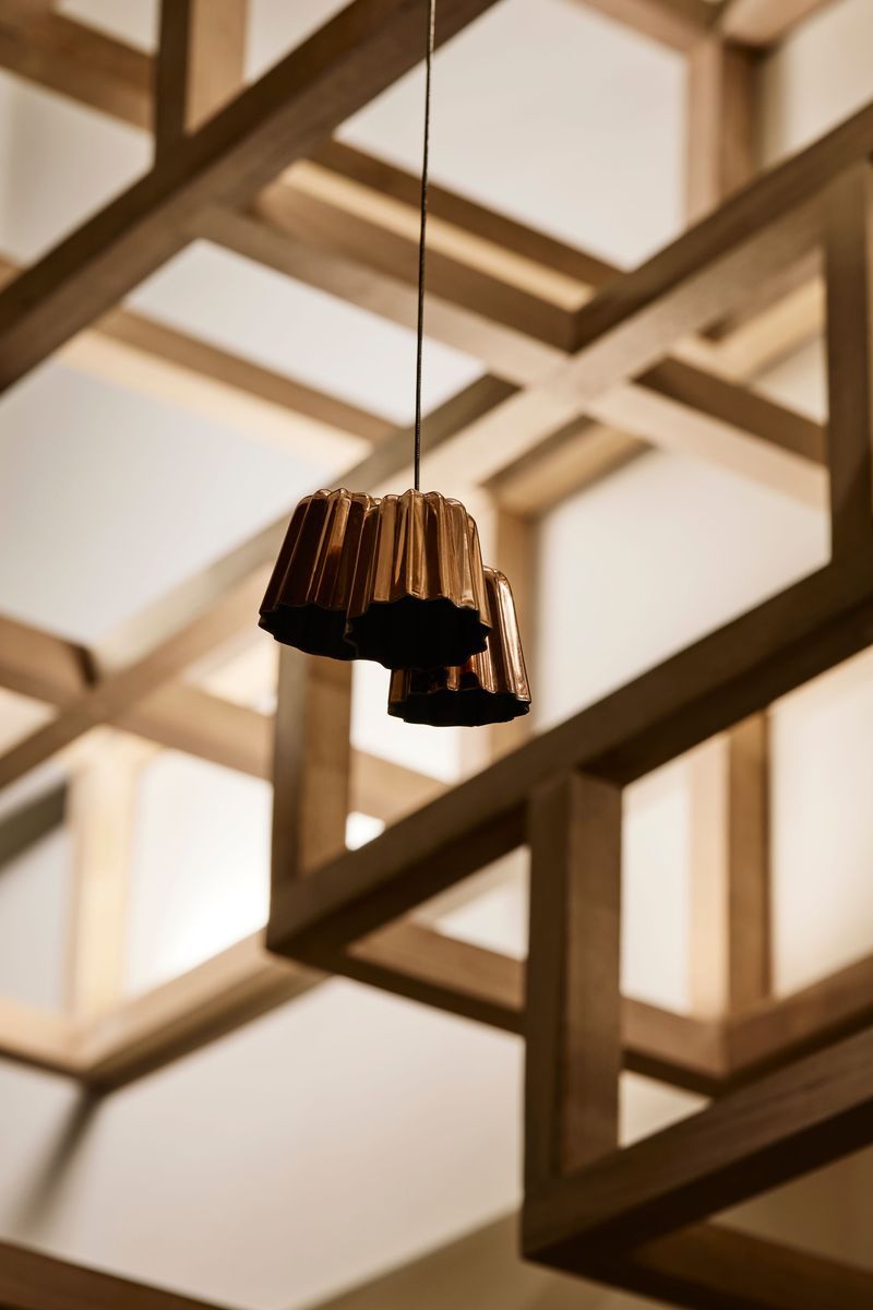 Copper canelé moulds suspended from the ceiling add character.