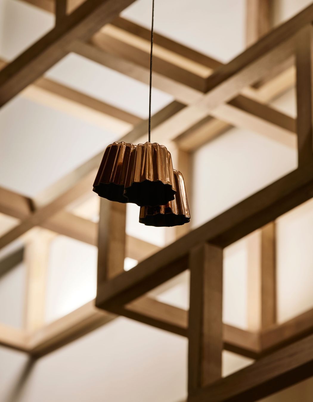 Copper canelé moulds suspended from the ceiling add character.