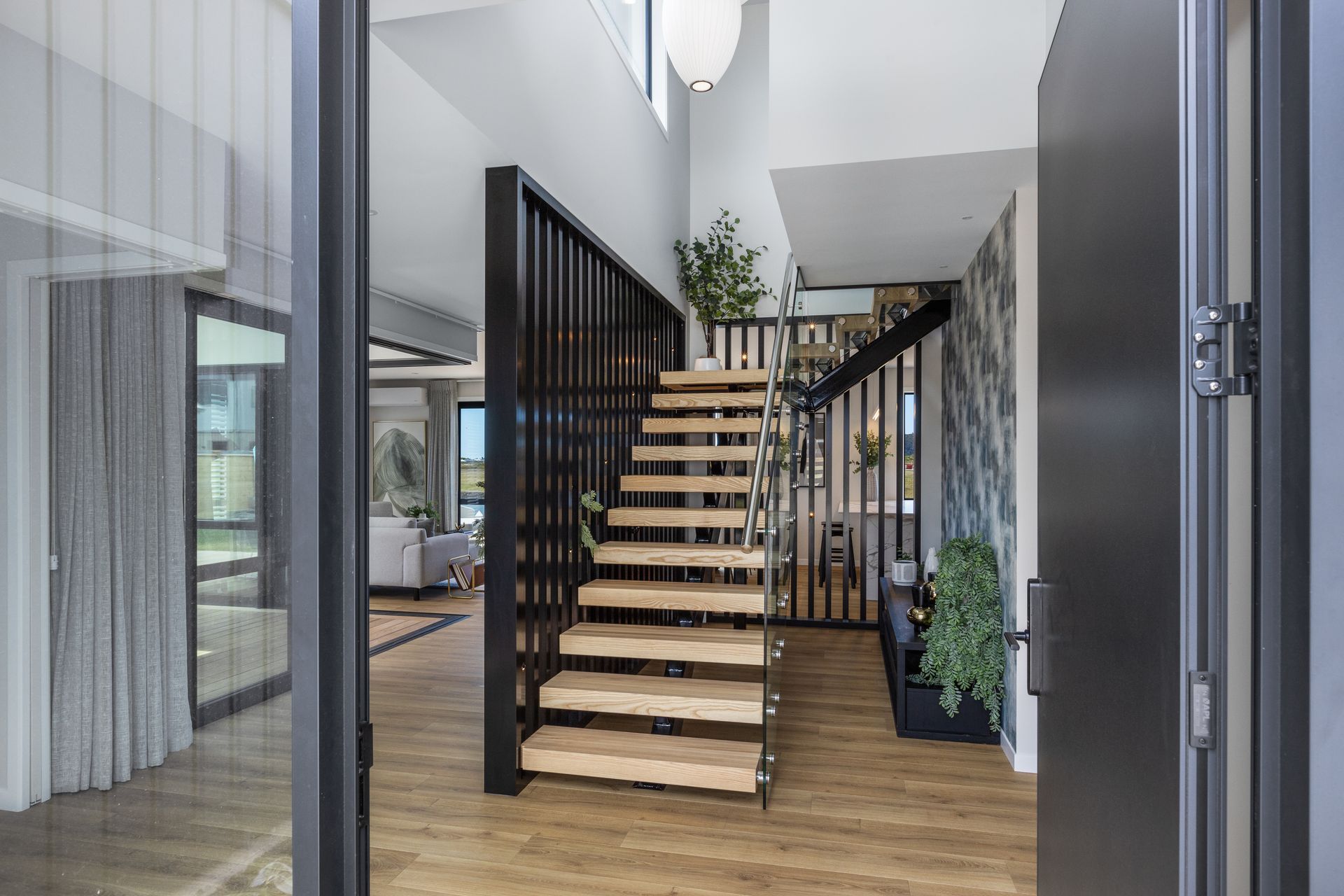 The stairwell leading to the second level creates a point of interest and sets the tone for the home’s sophisticated style.
