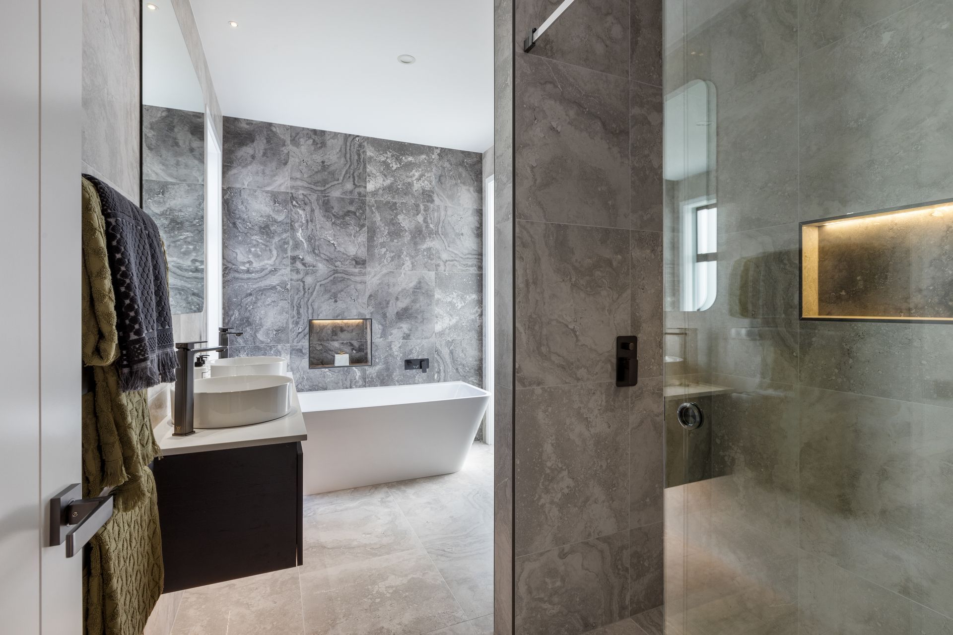 “A standout feature in both bathrooms is the innovative use of glass sliding doors for the showers. The doors not only add a modern touch but also enhance the sense of openness within the bathrooms.”