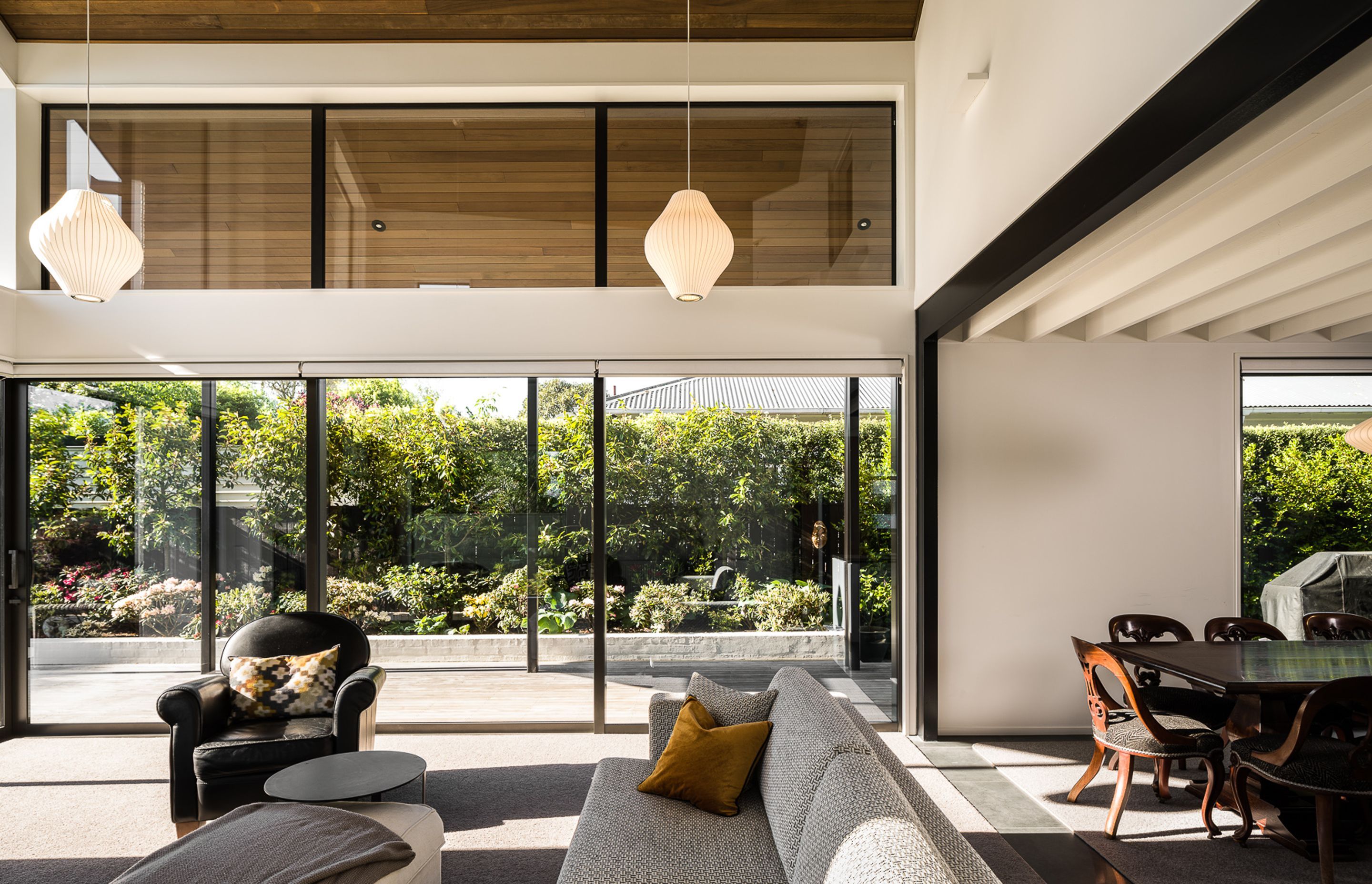 Large doors and windows look out to the back area of the house, allowing for ample sun and privacy.