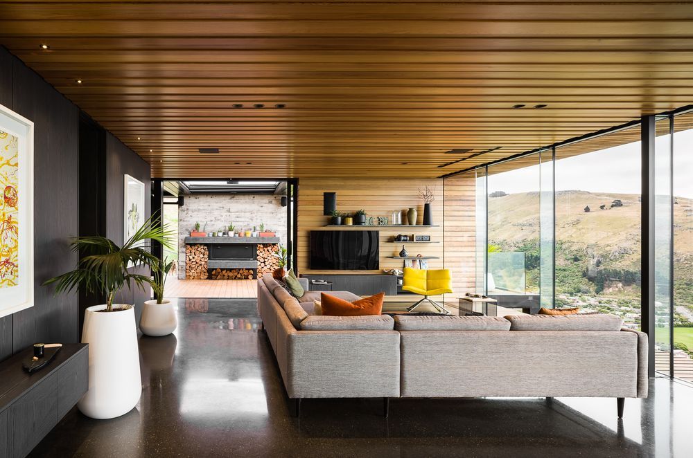 The open-plan living space leads directly to the outdoor living space through floor-to-ceiling sliders.