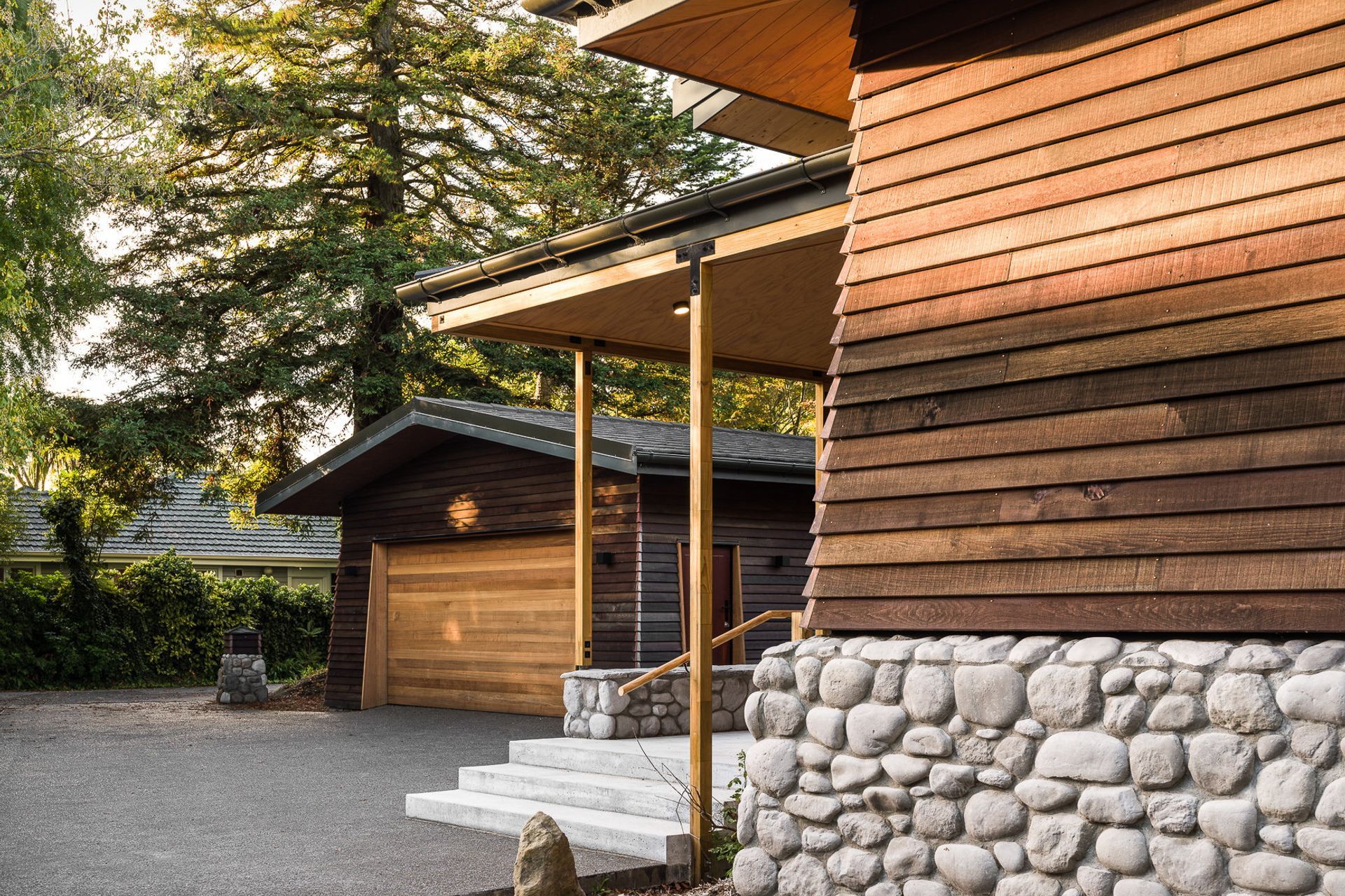 A long driveway marks the transition from the public to the private spaces. Its end reveals a California native, a grand, old redwood tree.