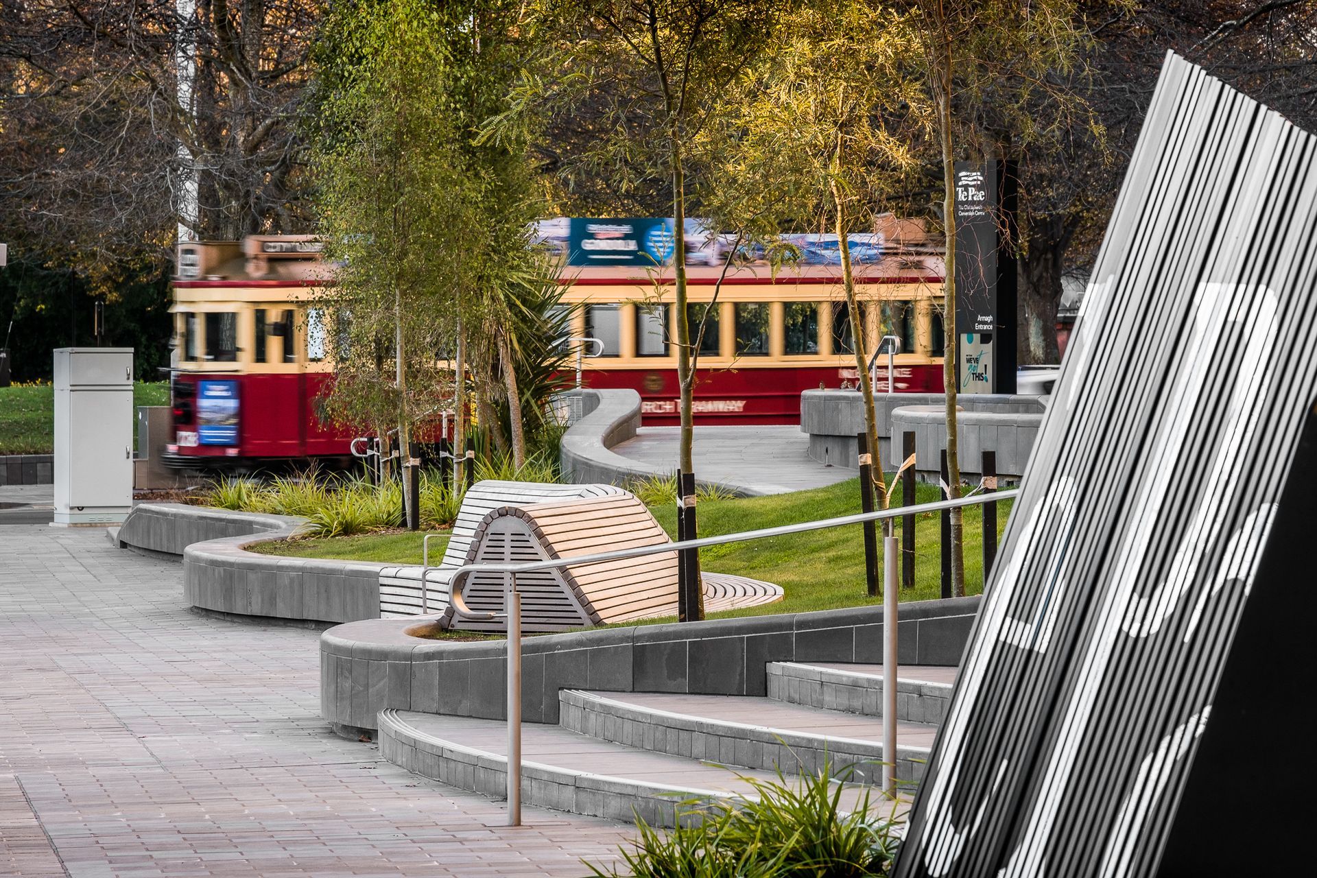 The landscape's curved walls and benches nod to the fluidity of the Avon River.
