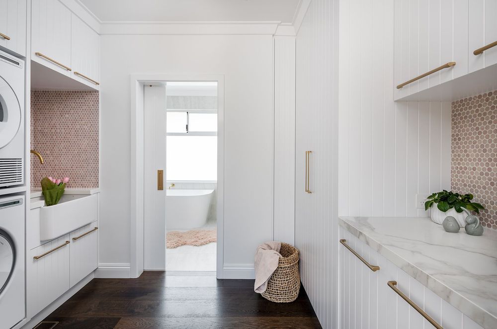 Hardwood, natural stone, brushed metal, greenery - a splendid mix of textures in this coastal barn style laundry room