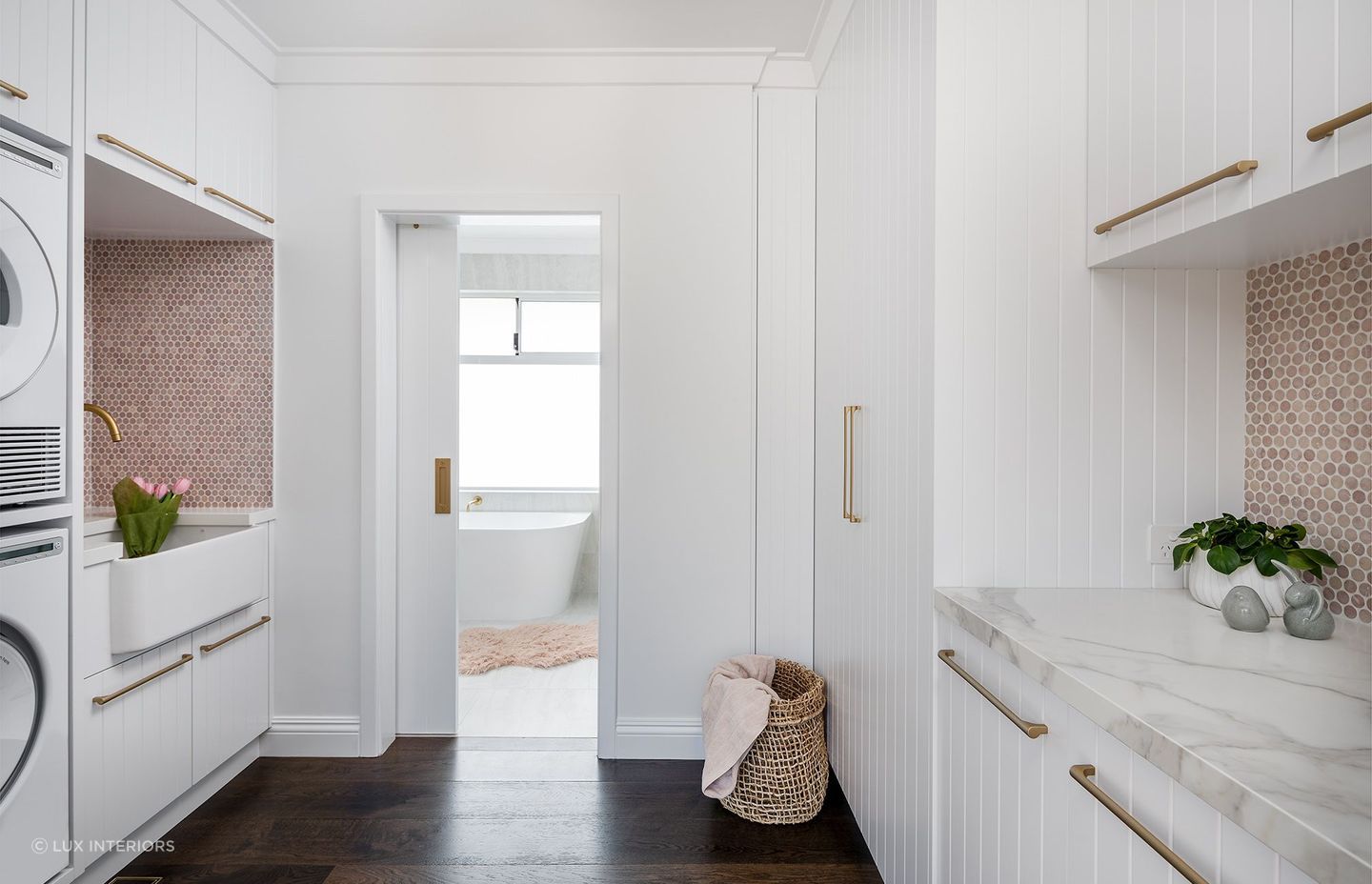 Hardwood, natural stone, brushed metal, greenery - a splendid mix of textures in this coastal barn style laundry room