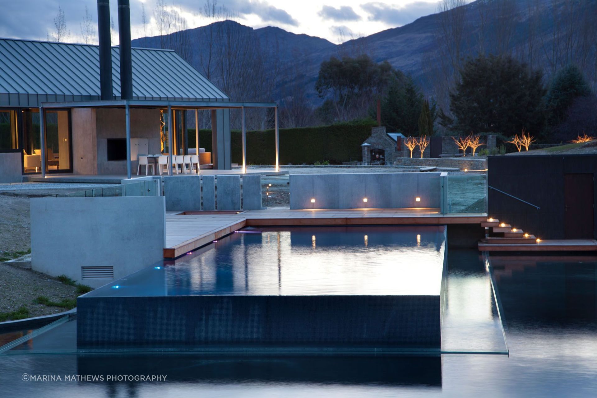 The pool spills over on three sides, running into the pond below.