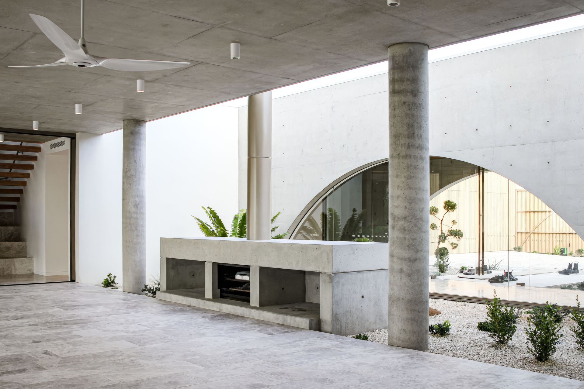 The stairwell and the entry space are glazed on either side, creating the feeling that indoor and outdoor spaces are one.