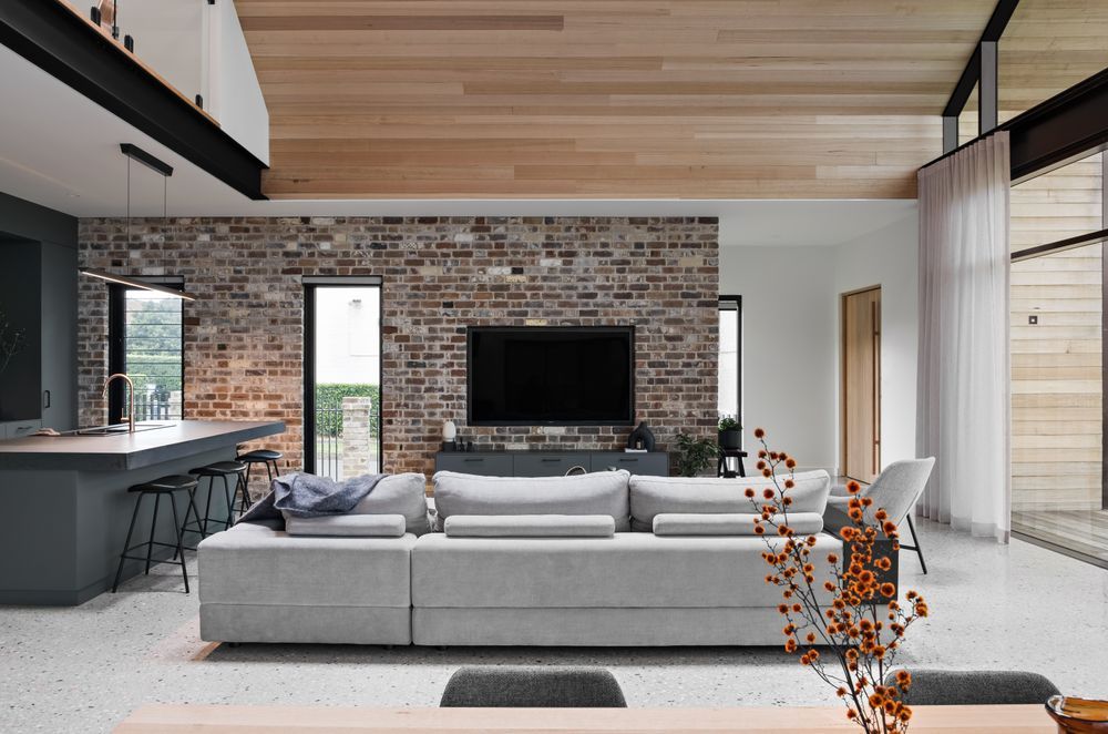 The New York loft references combine black metal, brick, and timber-lined ceilings.