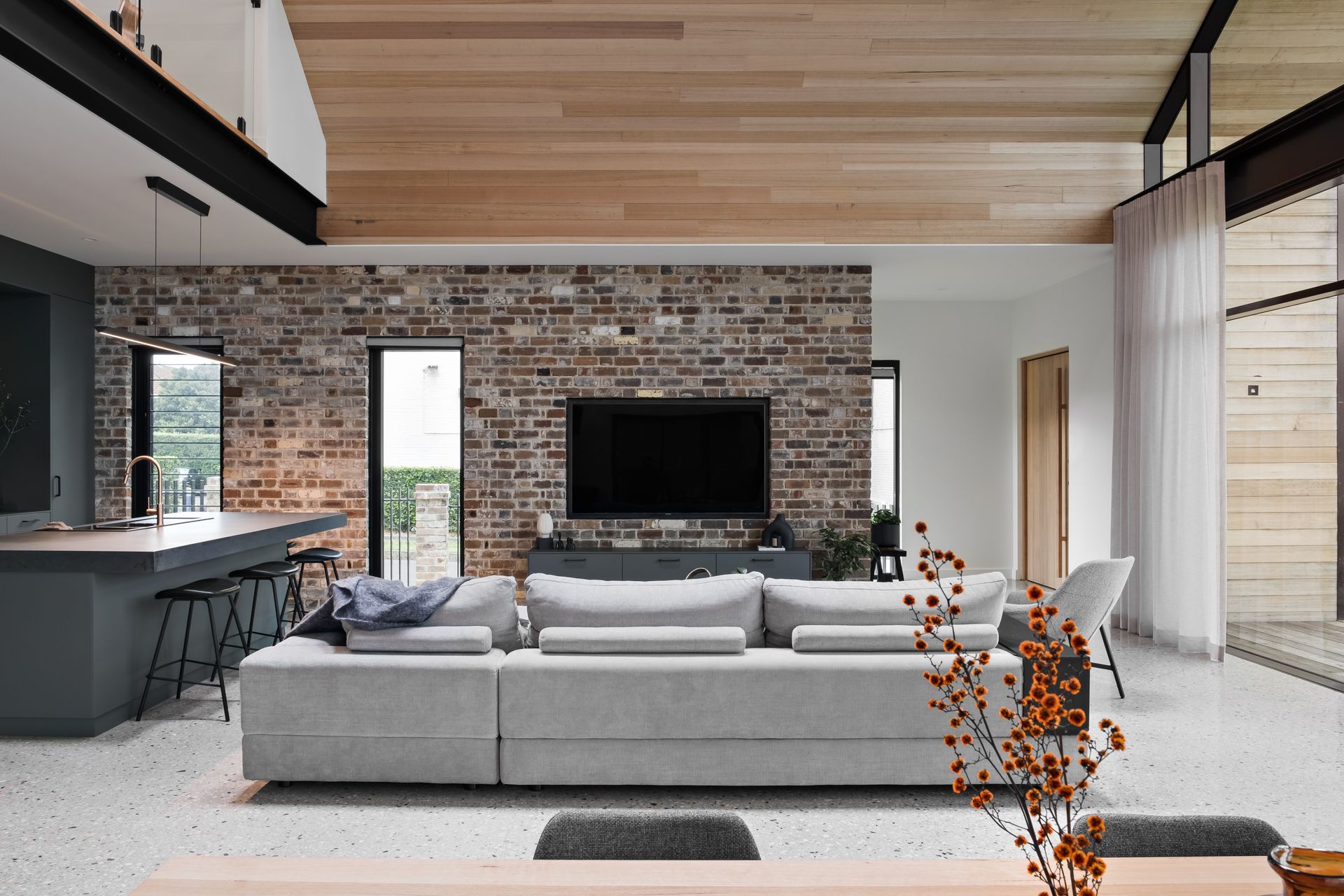 The New York loft references combine black metal, brick, and timber-lined ceilings.