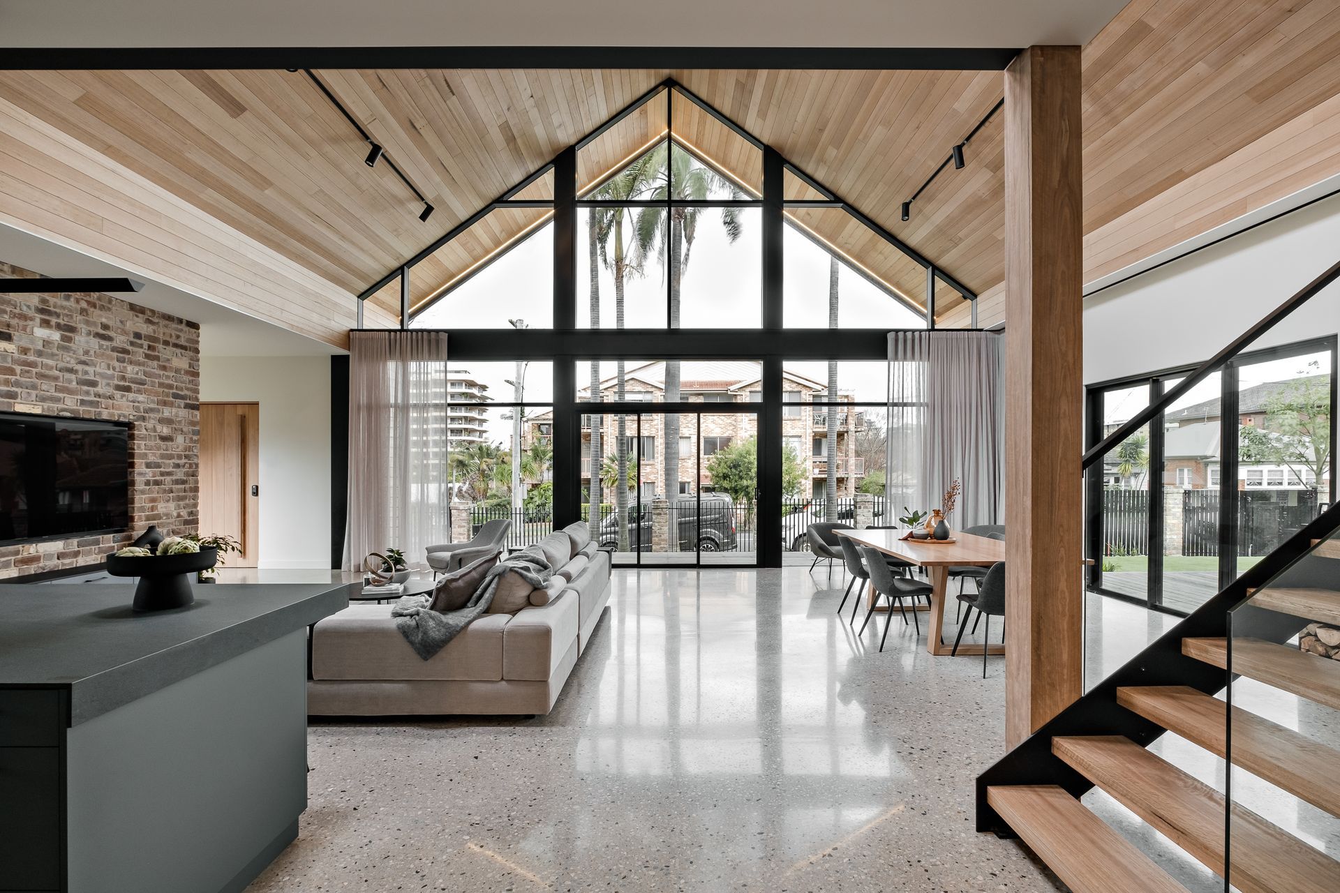 The timber lining on the ceilings is carried outside into the soffits; the simple A-frame architecture allows the materiality to take centre stage.