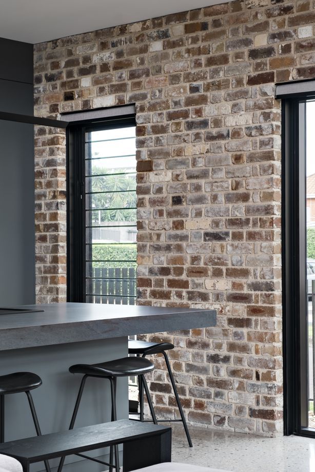 The recycled brick facade is carried through one wall of the interior.
